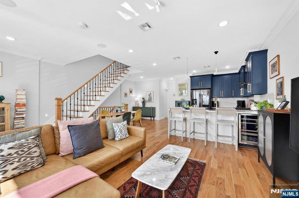 Welcome to this beautiful 3-bedroom, 2.5-bathroom condo in the heart of Jersey City Heights with a private roof deck and unobstructed views of Pershing Field Park and the NYC skyline. This bright and airy, east-facing home features an open layout with a sun-filled living area, floor-to-ceiling windows, and a Juliet balcony overlooking Pershing Field Park. The main level includes a powder room and a modern kitchen with stainless steel appliances and sleek cabinetry. Upstairs, the primary suite offers space for an office or den and an en-suite bathroom with porcelain tile, double vanity, and a lighted mirror. Two additional bedrooms and a full bathroom provide flexibility for guests, a home office, or other needs, with one bedroom offering access to a private balcony. A stacked washer/dryer is conveniently located in the hallway. The home also features a private 428 sq ft rooftop deck, ideal for outdoor entertaining or relaxing with NYC skyline views. Located one block from Central Avenue with quick access to local shops, restaurants, and everyday necessities. Conveniently near a bus stop with direct access to Port Authority in NYC as well as the Journal Square Path station. 1 off-street parking spot available nearby for an additional fee