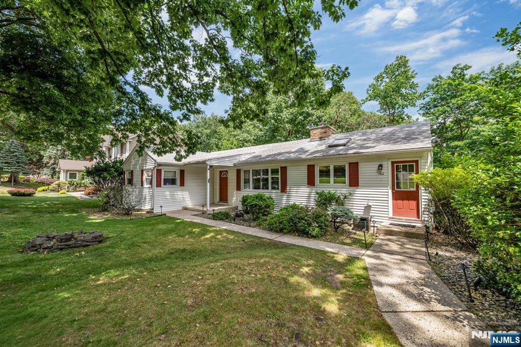 Extremely spacious 3-bedroom, 2.5-bathroom ranch located on a beautiful tree-lined street in one of North Haledon's most desirable neighborhoods. A long driveway and covered carport create a welcoming first impression, while the home's generous layout offers exceptional space for both everyday living and entertaining. The main level features 3 bedrooms, a large living room, formal dining room with a wood-burning fireplace, spacious kitchen, powder room, and an impressive family room addition that serves as the heart of the home. Convenient main-level laundry adds to the home's functionality. The finished walkout basement offers tremendous flexibility and significantly expands the living space. This level includes a large recreation room, full bathroom, wine room, utility area, second laundry room, and direct access to the backyard through a separate entrance, making it ideal for extended living, recreation, or work-from-home needs. Additional highlights include multi-zone hot water baseboard heating, central air conditioning, a whole-house natural gas generator, cedar closets, public sewer, well water, and a new Trex deck overlooking the property. Outdoor features include underground sprinklers and landscape lighting (both sold as-is). A rare opportunity to own a spacious, well-maintained ranch with a finished walkout basement in one of North Haledon's most sought-after locations.