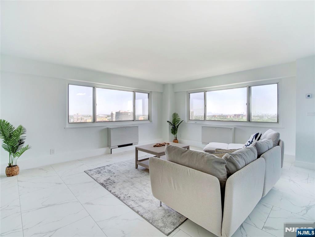 Rush over and see the newest gut renovated HPT beauty! This special corner unit one bedroom, one bath COOP has been carefully styled with fine details is ready for the next owner occupant. Northeast facing terraced unit was just completed and has a gorgeous new kitchen, new bath, a generous sized and well lit BR, and open LR with windows all around to take advantage of this 17th floor view. This well known Coop features a 24 concierge, included utils (electric, heat, hw), underground parking ($60/mo) - just 1 space avail, comp jitney to the NYC train and grocery stores, a backyard mature "secret garden", first floor gym and bright, clean basement laundry. Just blocks from access to GSP and Route 280, this is one of the best buys in Essex County! Coop board approval req and 20% down payment is a must. Ownership shares - 302. Monthly maint $1456. HOA includes taxes, maintenance and all utils (heat/AC, hw, electric). See details on entrance reqs and move-in fees. Sq footage is approx.