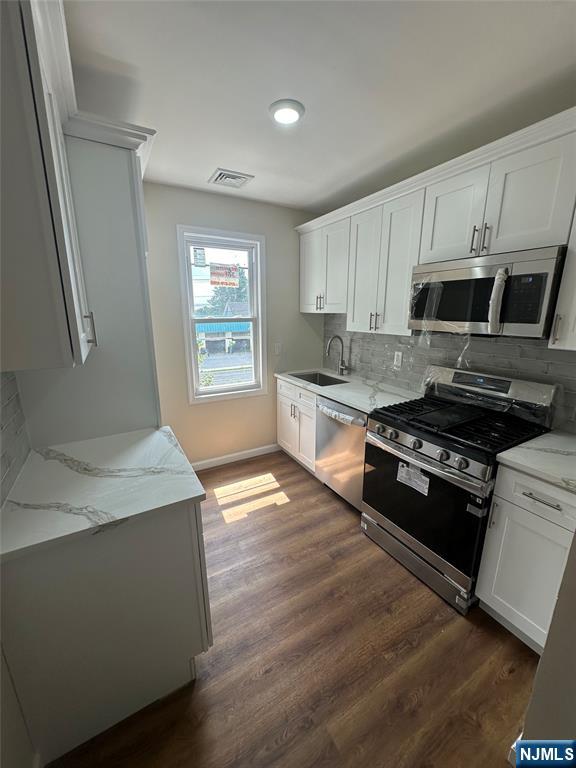 Broker commission paid by landlord if moving in ASAP ,ONE 20-MINUTE NO-STOP BUS TO MIDTOWN MANHATTAN, STEPS AWAY (NJTransit 158, 165, 168 to Port Authority - this is the VERY LAST stop before Port Authority!) Welcome home to this beautifully renovated apartment featuring a bright, open layout with stylish modern finishes throughout. The spacious kitchen is equipped with stainless steel appliances, white shaker cabinets, marble-look countertops, and a sleek tile backsplash perfect for cooking and entertaining. Enjoy plenty of natural light in the large living area with new hardwood-style flooring and ceiling lighting for a warm, inviting atmosphere. Both bedrooms offer ample space and flexibility for a cozy retreat or a home office setup. The updated bathroom includes elegant tile work, a full tub/shower combo, and a contemporary vanity with extra storage. Commuters will love the unbeatable location just steps to direct NJTransit buses for a quick 20-minute no-stop ride to Midtown Manhattan! Convenient laundry set up and storage space in basement and one car parking spot included . Schedule a viewing today before it's gone!