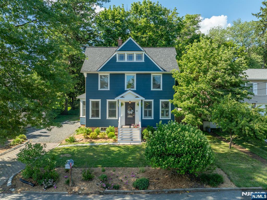 Beautifully Renovated Colonial situated on a level lot, blending timeless character with today's modern finishes. From the moment you step inside, you'll appreciate the bright, kitchen that flows effortlessly into the dining room with all new lighting fixtures. The main level also features a convenient laundry room and stylish powder room. The warm and inviting living room showcases high ceilings with elegant crown molding, an original brick wood-burning fireplace with wood stove, and ornate antique steam radiators that preserve the home's rich history while adding undeniable charm. Step outside to the covered back porch, complete with a ceiling fan, making it the perfect place to relax and enjoy the outdoors throughout the seasons. Upstairs, you'll find hardwood floors throughout, 3 comfortable bedrooms, a full hall bathroom, and charming built-in bookcases that enhance the character of the upper hallway. Original antique doors with vintage hardware have been thoughtfully preserved, allowing the home's 1907 craftsmanship to shine alongside its tasteful modern updates. The finished walk-up attic provides versatile storage or bonus space. With its blend of historic charm and modern convenience, this move-in ready Colonial offers plenty of character. Come experience the beauty appeal this exceptional home has to offer!