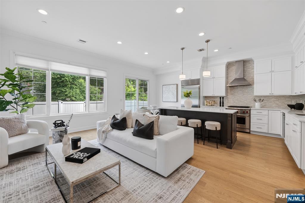 Stunning luxury corner townhome in Gabriel Estates, a boutique community in the heart of Paramus. Built just a few years ago, this residence has 3 bedrooms, 2 full baths, and 2 half baths, the home offers soaring 10-ft ceilings on the main level and 9-ft ceilings upstairs, creating a bright, airy ambiance. The gourmet kitchen showcases Sub-Zero and Wolf appliances, quartz countertops, and sliding glass doors that open to a private, fenced backyard. The impressive primary suite includes a massive walk-in closet and a spa-like bath with a Jacuzzi tub, oversized shower, and a double vanity. A fully finished lower level extends the living space with a spacious recreation room and a custom wet bar perfect for entertaining. Outdoor living is complete with a private patio and yard, all just minutes from the Garden State Parkway, Route 17, world-class shopping, and Paramusâ€™ top-rated schools.
