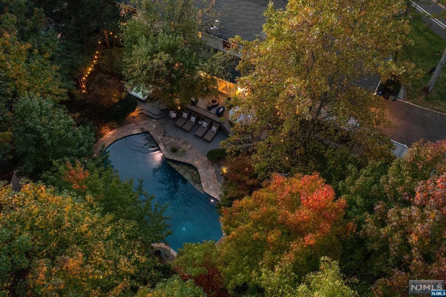 Make your next vacation a permanent one at 76 Tree Top Drive! Backing up to Baltusrol Golf course & situated in sought after 'Baltusrol Top'. From the moment you walk in the front door & throughout the 1st fl, you will enjoy continuous views of the backyard oasis! Renovated top to bottom featuring new windows doors floors & moldings. New applncs/utilities including full house generator. On the 1st floor you will find living, dining rm & open concept family rm & high end kitchen with ideal flow to the outdoor space. The 1st Fl. primary bdrm has a brand new marble bth rm featuring steam shower, heated towel rack & flrs, soaking tub & 2 walk-in closets- 1 of which has its own mini fridge! On the 2nd floor you will find 4 bdrms & 2 full bths. Finished bsmnt provides a huge rec. rm w/ full bar. Whether you are bellying up to the custom snack bar window after a dip, roasting marshmallows in the fire pit area or enjoying a snowy night in the hot tub, the fun never stops at 76 Tree Top!