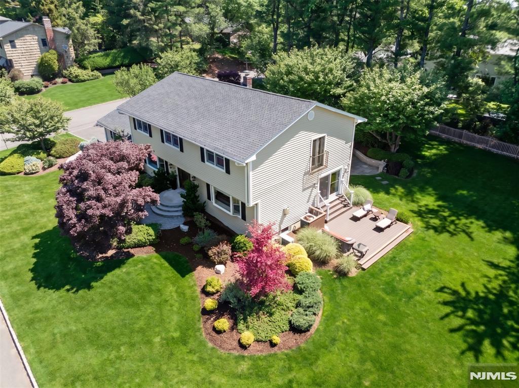 Set gracefully on a knoll on Hillsdale's highly sought-after & rarely available West Hill, this exquisitely renovated Center Hall Colonial offers an exceptional combination of luxury, comfort, & panoramic beauty. With five bedrooms & 3.5 baths, this distinguished residence is thoughtfully designed for today's discerning homeowner. The home showcases stunning New York City skyline vistas from the Family Rm & deck. Bathed in natural light through large windows & desirable east-west exposure, the open floor plan creates a seamless flow between living spaces, enhancing everyday living & sophisticated entertaining. At the heart of the residence is a spectacular renovated center island gourmet kitchen featuring generous workspace, hi end finishes, & an inviting brkfast area overlooking the beautifully property. The kitchen opens to the Family Rm & Living Rm, where hardwood flooring, a gas fireplace, & abundant natural light create warm & welcoming gathering spaces, plus a 5th bedrm, laundry rm & pdr rm. Upstairs, the expansive Primary Suite serves as a luxurious retreat, w/2 walk-in closets & a renovated spa-inspired bath. Three additional spacious bedrms & a renovated main bth complete this level. Designed with entertaining in mind, the finished lower level offers a custom bar, wine cellar, home theater area, home office, & a bth/stall shower. Outside, the professionally landscaped grounds & Koi pond create a setting that is both beautiful & peaceful throughout every season.