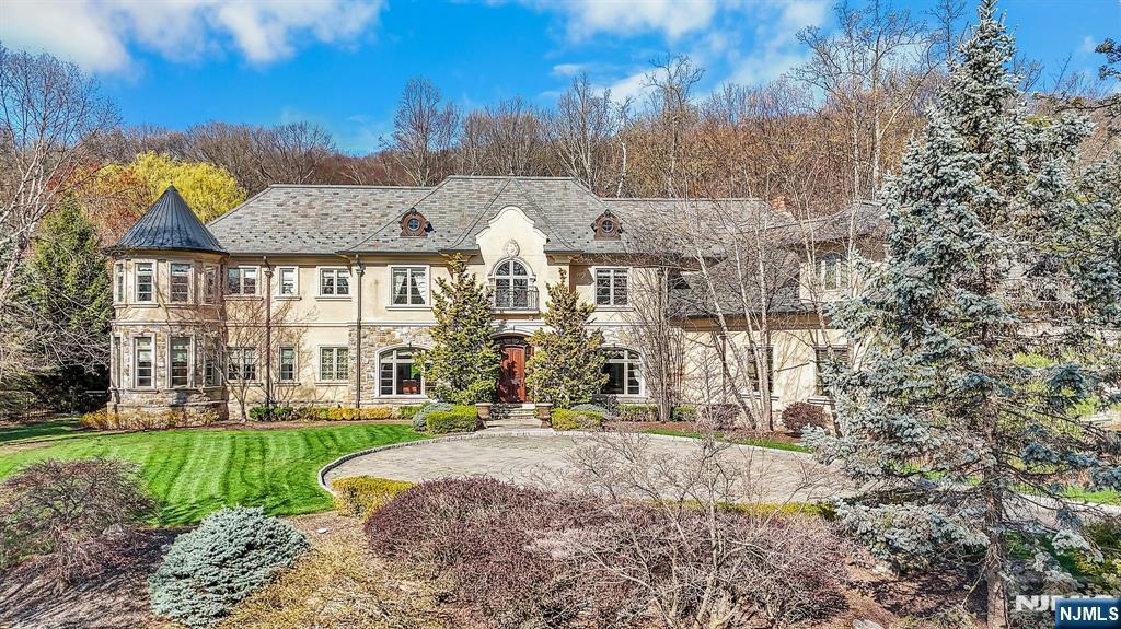 Luxurious living in the enclave of The Pond. 1+ acre of landscaped property, custom-built estate offers 7,300+ sq ft of refined elegance not including the LL. Grand open fl plan w/ vaulted ceilings, arched doorways, custom moldings & built-ins blend timeless charm w/ modern sophistication. Sunlight pours in through oversized windows, highlighting every detail. Gourmet kitchen features high end appliances, WB fireplace, pizza oven & center island w/ seating. Great RM w/ ornate ceilings, gas fireplace & wet bar, add'l spaces incl a living RM, library & wine RM. Main fl BR w/ bath, laundry & powder RM adds convenience. Upstairs primary suite is a true retreat w/ gas fireplace, his & her walk-in closets & bath w/ jetted tub, walk-in shower & dual vanities. 3 add'l. BR are en-suite w/ bathrooms & walk-in closets, 2nd laundry RM adds functionality. LL incl family, media, exercise RMS & bathroom. Outside enjoy the patio, outside bar area, pond w/ waterfall, pickle ball ct & lush grounds.