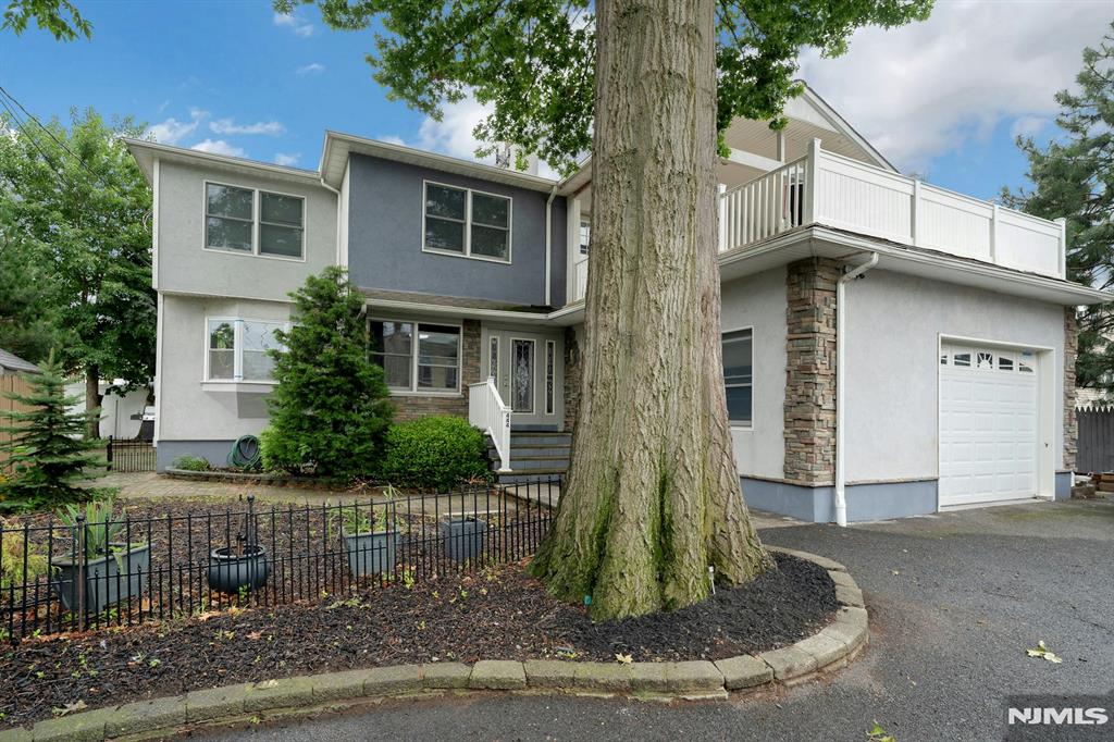 Welcome to this beautiful Colonial home offering 4 bedrooms and 4 full bathrooms. Completely renovated and expanded in 2005, this move-in-ready home combines timeless charm with modern amenities. Features include central air conditioning, recessed lighting, and quality flooring throughout. The first floor offers a bright living room featuring custom built-in cabinetry and a fireplace, a formal dining room, an updated kitchen, two spacious bedrooms, a full bathroom, and a private enclosed porch off one of the bedrooms. The second floor features a spacious primary suite with a private bath, an additional bedroom, another full bathroom, a large family room with a wet bar and a large private terraceâ€”perfect for relaxing or entertaining. The partially finished basement includes a full bathroom and provides additional flexible living space. Outside, enjoy a huge detached garage, a long driveway with parking for five or more vehicles, and a private side yardâ€”ideal for entertaining, gardening, or simply relaxing. Ideally situated directly across from Bergen County Riverside Park, this home offers easy access to walking and biking trails, playgrounds, and open green space. Shopping, restaurants, schools, and major highways are just minutes away, and NYC bus service is conveniently located on the corner, making commuting simple. This beautifully updated Colonial offers exceptional living space, quality craftsmanship.