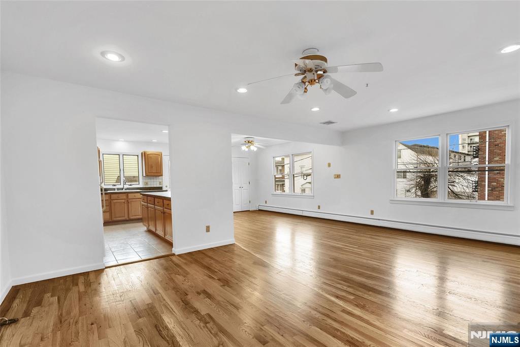 Vacant and easy to show, this spacious duplex apartment is ideally located just minutes from NYC. The first floor features an open layout with a large living room, dining room, and kitchen with direct access to a private deck. Additional first-floor highlights include a primary bedroom with an en-suite bath, a second bedroom, and a powder room. The second floor offers two additional bedrooms and a full bathroom. As a desirable corner unit, the home enjoys abundant natural light, generous closet space, and the convenience of ground-floor laundry. Private entrances provide added convenience and exclusivity, ensuring a seamless entry into the home. Completing the property is a two-car attached garage with an automatic door opener, plus two additional driveway parking spaces. Tenant pays Electricity, Gas and Hot and Cold Water.