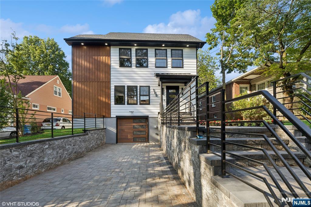 Experience Modern Elegance in the Heart of Maplewood. Welcome to this exquisite new construction luxury residence nestled in one of Maplewood's most sought-after neighborhoods. Boasting 5 spacious bedrooms and 4.5 designer bathrooms, this meticulously crafted home offers the perfect blend of sophistication functionality and upscale living.From the moment you enter you'll be captivated by the rich hardwood floors soaring ceilings and an abundance of natural light that floods every room. The custom chef's kitchen is a culinary masterpiece featuring premium Viking appliances, sleek cabinetry and an expansive island perfect for entertaining.Retreat to the opulent primary suite complete with a spa-inspired bath and a private balcony ideal for morning coffee or quiet evenings.Each bedroom is generously sized with en-suite baths designed for comfort and style.Step outside to discover your personal oasis highlighted by a private pickleball court manicured grounds and serene outdoor living spaces that elevate every gathering.Additional features include:Open-concept layout ideal for entertainingDesigner lighting and high-end finishes throughout including a finished basement.Convenient access to NYC-bound public transportationAttached garage and ample storageThis is more than a home it's a lifestyle. EV connection ready & Smart Home Enabled! Whether you're hosting elegant soirees or enjoying peaceful mornings this property delivers the ultimate in modern luxury and suburban convenience