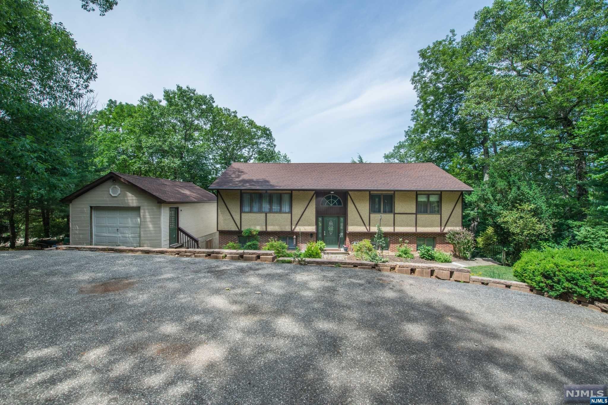 Immaculate, Custom Bi-Level located in Erskine Lake. Located on a large, private, wooded lot in Great Neighborhood. Lots of Generous Room Sizes to Spread Out & Make Your Own! Layout offers versatile options! GREAT house for entertaining or everyday living. Large living room & formal dining room with slider to back deck. Bright, eat-in kitchen- granite countertops & glass tile backsplash. Abundance of high hats & large windows -Lots of light! 3 large bdrms & 2 renovated full bath upstairs includes the primary suite w/bath (walker accessible stall shower). Oak hardwood flooring throughout. 3 additional office/den/flex rooms on lower level. Fully equipped w/the third full bath. Kitchenette area with separate entrance. Family room walks out to the lower deck. Convenient laundry/mudroom. Oversized detached garage. Over 2800 sqft of living. Seasonal Lake views. Tons of parking! 3 quarters of an acre. An ideal spot to relax on the deck & enjoy life amongst the tree line. Erksine Lake.