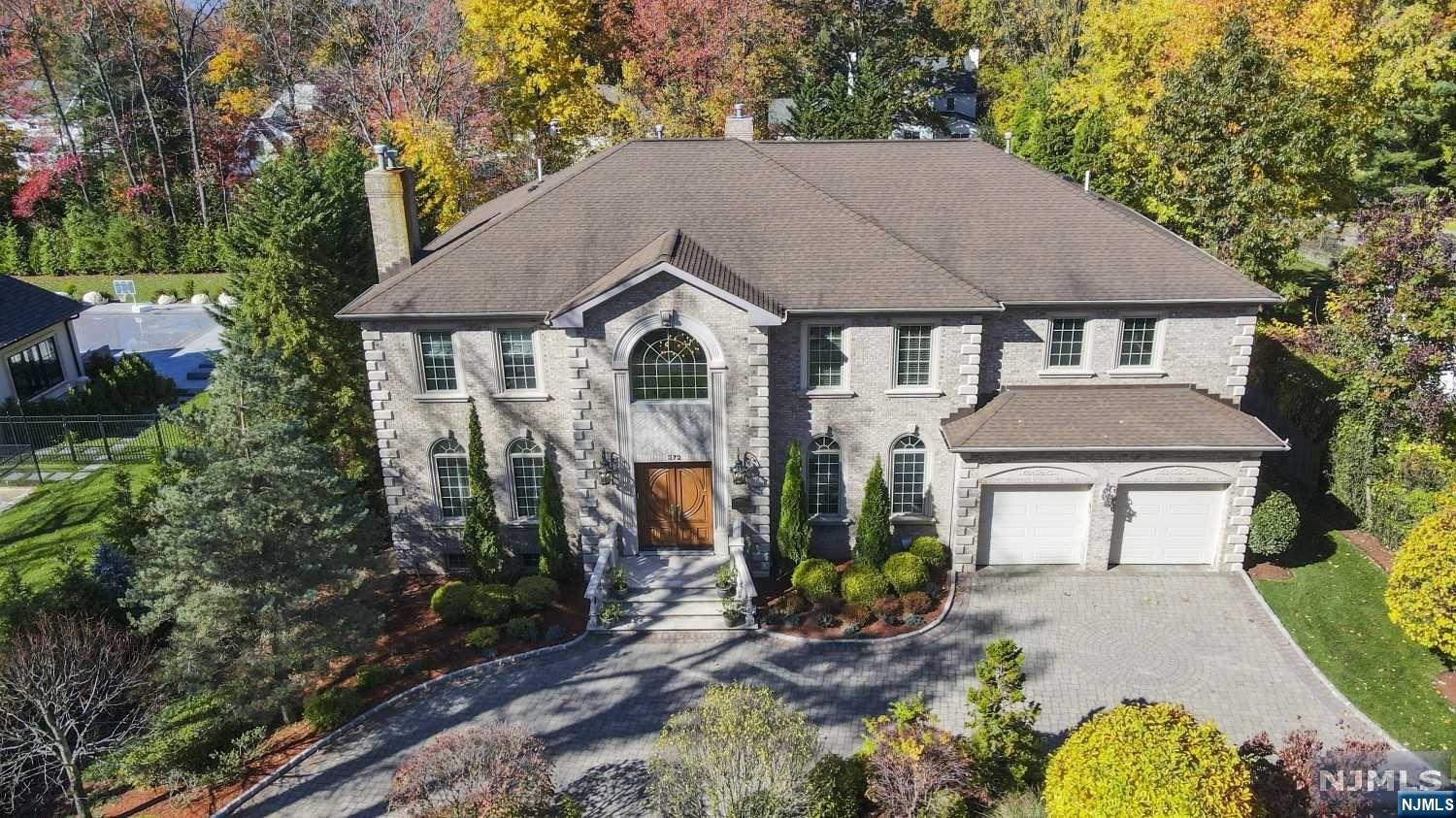 Timeless yet modern lux brick COL in coveted E. Hill Englewood. Designed w/A+ craftsmanship set on a spectacular half-acre(+/-) w/generously proportioned living spaces. Luxuriate w/HDWD FLRS, soaring ceilings & EIK w/Viking & Sub-Zero APPL. Relax & entertain in a large flat yard w/lush landscaping & a selection from your wine cellar. Ample storage space, huge fitted closets & the ultimate work-from-home space in a large 1st Flr office/ensuite BR. Great rm's soaring 30' ceilings & natural light from E-W windows greet you dramatically, elevated by oversized gas FPL flanked by glass french doors to Euro-inspired stone terrace. Chef's kitchen w/granite center ISL, wet bar, powder rm & FDA round out 1st Flr. 2nd Flr sun-filled catwalk leads to 4 signif. BRs incl. primary bed/bth walled w/huge window overlooking BKYD. Completing the stately home is a fully finished BSMT w/2nd LNDY, full bth, gym, wine cellar & rec room. 25k kilowatt generator, close to houses of worship, 5 miles to NYC