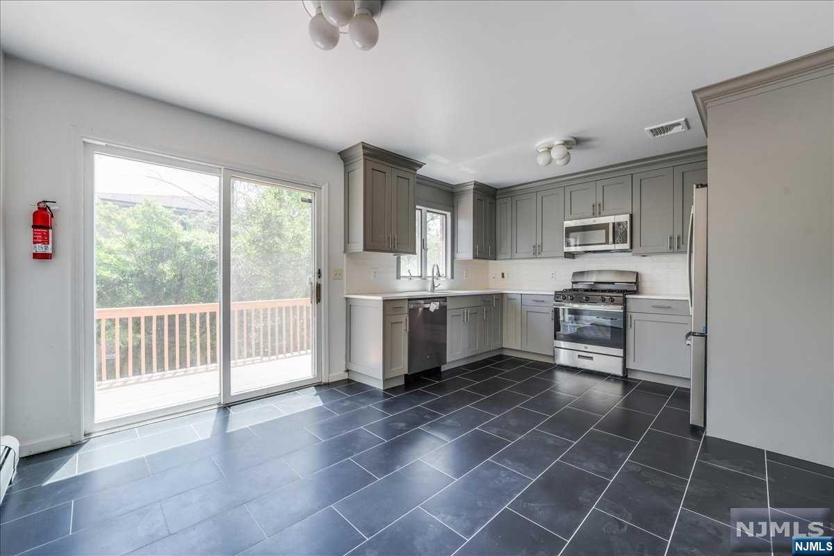Welcome to this beautifully updated home in the heart of Palisades Park, offering a perfect blend of modern convenience and classic charm. This spacious 3-bedroom, 3.5-bathroom home is ideal for comfortable living and entertaining. The first floor features a newly updated kitchen with modern appliances, an open concept living room and dining room perfect for family gatherings and entertaining, and a convenient half bath for guests. On the second floor, you'll find a large primary bedroom with an ensuite full bathroom providing a private retreat, two additional generously sized bedrooms, a full bathroom in the hallway easily accessible from the additional bedrooms, and a skylight in the upstairs hallway filling the space with natural light. The ground level includes an attached garage with direct access to the home, a finished recreational room perfect for a home gym, playroom, or additional living space, and a full bathroom for added convenience.This home is equipped with central