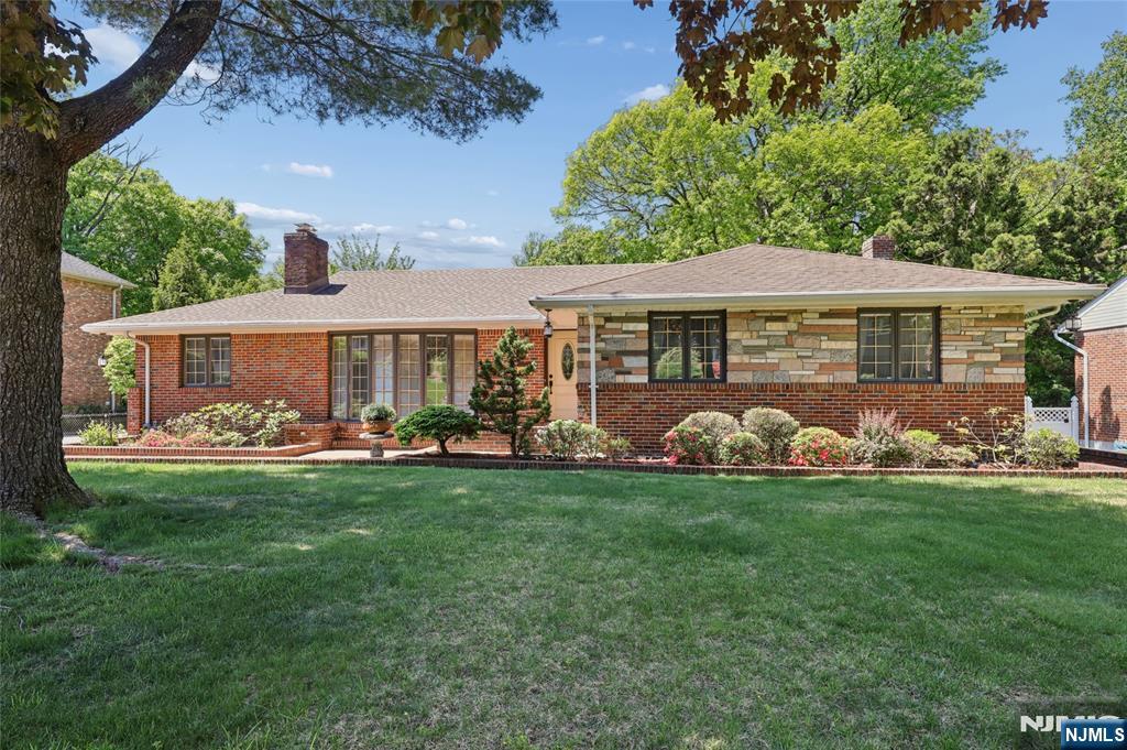 Welcome home to this stunning all-brick ranch nestled on the sought-after north side of Englewood Cliffs. With its coveted east-facing orientation, enjoy gorgeous morning light pouring through every custom window.The brick-paved driveway extends all the way to the backyard, and sets the tone for a home that has been meticulously cared for and thoughtfully upgraded. Step inside to discover warm wood-paneled walls and hardwood floors throughout. Both the living room and family room are anchored by wood-burning fireplaces â€” perfect for relaxing evenings and effortless entertaining. The modern kitchen impresses with granite countertops and quality cabinetry, making it both functional and beautiful.A newer HVAC system, recently replaced hot water heater, and updated roof mean the big-ticket items are taken care of â€” so you can simply move in and enjoy. Ground-level basement offers incredible flexibility with a summer kitchen, family room, half bath, private office, generous storage, and a two-car garage. 4 bedrooms,2.5 bathrooms,Lot 102 X 80. Hard to beat location; commuting to New York City has never been easier.