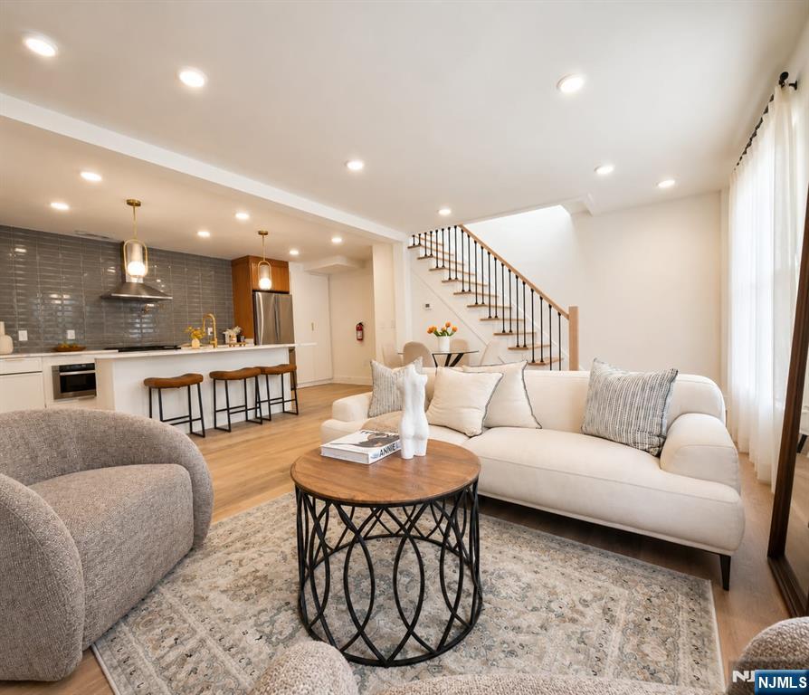 Rare opportunity to own a true single-family home in the highly sought-after Jersey City Heights no condo fees, just modern luxury, privacy, and incredible curb appeal. This bright and sunny home features 3 bedrooms and 3 full ensuite bathrooms, including a first-floor bedroom perfect for guests or flexible living. Step inside to an open-concept layout showcasing oversized 8-foot doors, skylights, high end designer finishes, gleaming hardwood floors and abundant natural light throughout. The stunning chef-inspired kitchen flows seamlessly into the living and dining areas, creating the perfect space for entertaining and everyday living. Enjoy a finished basement ideal for additional living space, gym, office, or media room, along with a private deck directly off the bedroom for your own peaceful retreat. Located in a prime Jersey City Heights community near parks, shopping, restaurants, Light Rail, PATH, buses, and direct NYC transportation a true commuter's dream.