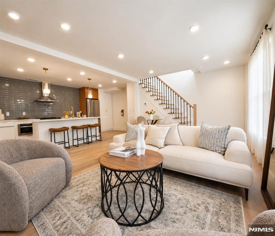 Rare opportunity to own a true single-family home in the highly sought-after Jersey City Heights no condo fees, just modern luxury, privacy, and incredible curb appeal. This bright and sunny home features 3 bedrooms and 3 full ensuite bathrooms, including a first-floor bedroom perfect for guests or flexible living. Step inside to an open-concept layout showcasing oversized 8-foot doors, skylights, high end designer finishes, gleaming hardwood floors and abundant natural light throughout. The stunning chef-inspired kitchen flows seamlessly into the living and dining areas, creating the perfect space for entertaining and everyday living. Enjoy a finished basement ideal for additional living space, gym, office, or media room, along with a private deck directly off the bedroom for your own peaceful retreat. Located in a prime Jersey City Heights community near parks, shopping, restaurants, Light Rail, PATH, buses, and direct NYC transportation a true commuter's dream.
