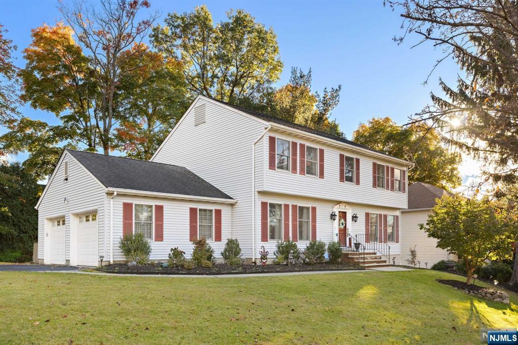 Welcome to this stunning center hall colonial, beautifully situated on a desirable corner lot. Step inside to a grand entry foyer that invites you into a spacious living room, elegant formal dining room, modern kitchen boasts top-of-the-line Wolf and Subzero appliances, granite countertops and center island complemented by sliding doors that lead to a large deck, family room features a gas fireplace, powder room and laundry area complete the first floor. Upstairs, the primary bedroom offers a serene retreat with a full bath and WIC closet, along with three additional bedrooms and a full bath. Large full finished basement with cedar closet and plenty of room for entertaining. Professionally landscaped with a sprinkler system, this home not only looks stunning but is also easy to maintain. Located in a blue ribbon school district and ideal for the NYC commuters. Truly a place to call home!