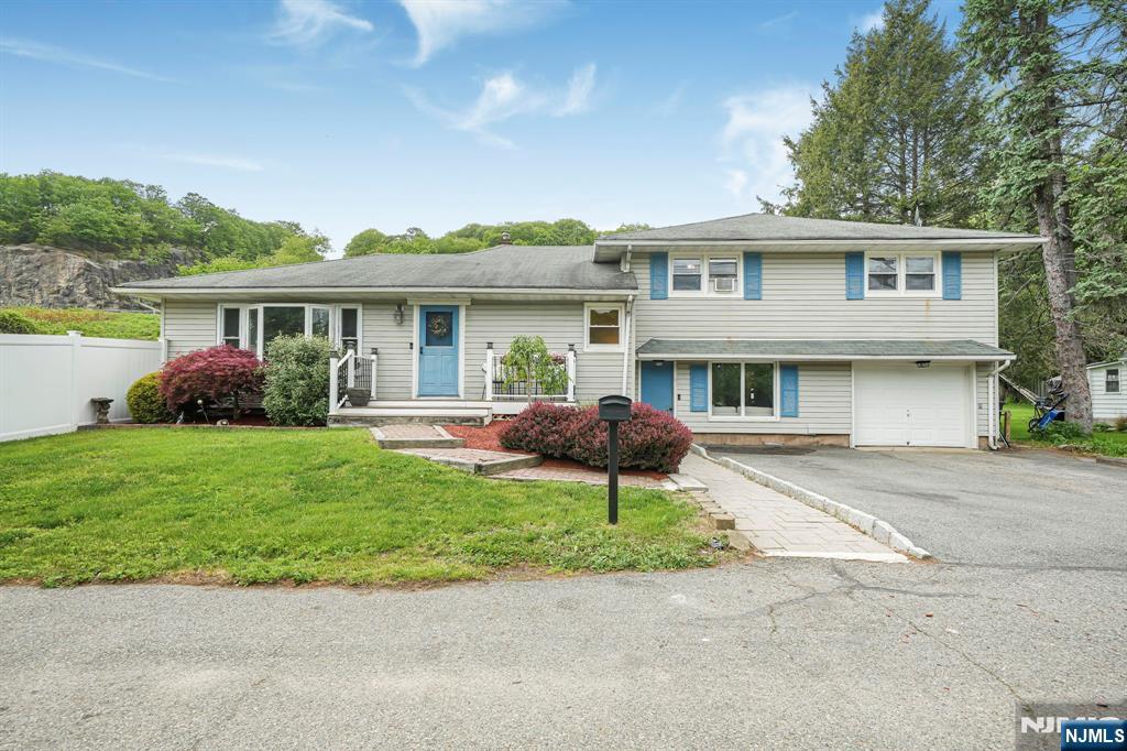 Best & Final offers are due by Wednesday, May 27th by 5pm. Nestled in desirable Pompton Lakes, this charming 4-bedroom split-level offers space, character, and great entertaining opportunities both inside and out. The open-concept main living area features soaring ceilings in the kitchen, exposed stone accents, a spacious living room with pocket doors, dining area, and cafe;-style seating space filled with natural light. A first-floor bedroom and nearby full bath provide flexible living options. The lower level includes a welcoming family room with large picture window, laundry area, and home office. Upstairs offers 3 spacious bedrooms and a full main bath. Looking for extra fun space? â€œThe caveâ€ is the perfect escape for game nights, hobbies, or relaxing. Enjoy the fenced-in backyard complete with deck and gazebo, lower patio, above-ground pool, and outdoor bar area made for entertaining. Conveniently located near Pompton Lakesâ€™ charming Main Street shops, restaurants, schools, parks, and NYC transportation.