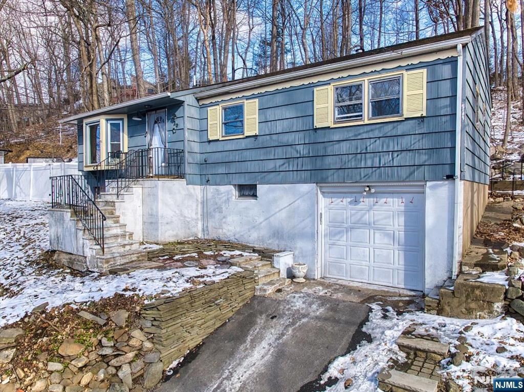 Welcome to 39 Ramapo Hills Blvd, a charming single-family home nestled in the heart of Oakland, New Jersey. This delightful residence offers comfortable living with its two spacious bedrooms (possibly 3) and 2 full bathrooms. As you step inside, you'll be greeted by a sunlit living room featuring a large bay window and hardwood floors that flow seamlessly into the formal dining room. The dining area boasts sliding doors that open to a deck and patio, providing a serene setting for outdoor relaxation and entertainment. The well-appointed kitchen comes equipped with ample cabinetry and a cozy breakfast nook, perfect for morning meals. The main level also includes a generous primary bedroom with a walk in closet and an additional bedroom, and a full bathroom. The lower level offers ample storage space, a utility area, laundry facilities, and a versatile bonus room that can serve as an entertainment area, gym, or home office and bedroom. A second full bathroom on this level adds to the home's convenience. Built in 1958, this ranch-style home sits on a 0.26-acre lot and includes a one-car attached garage. The property's location in Oakland provides a rustic suburban feel while being just 30 miles from Midtown Manhattan, offering the perfect blend of tranquility and accessibility. Don't miss the opportunity to make this charming residence your new home. Experience the best of Oakland living at 39 Ramapo Hills Blvd.