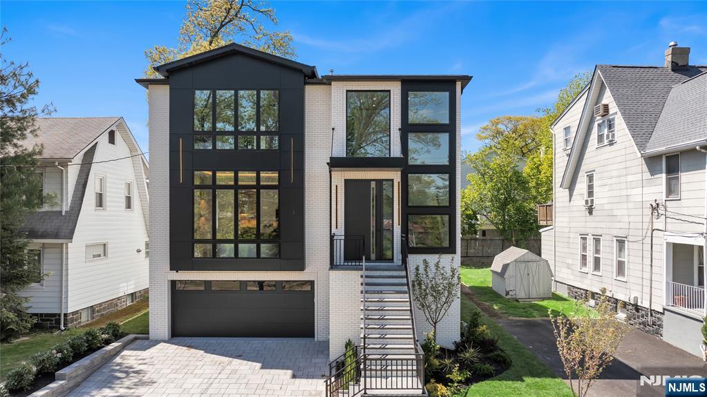FRAMED BY A PICTURESQUE, PARK LIKE MEDIAN, THIS NEW CONSTRUCTION LUXURY RESIDENCE SEAMLESSLY BLENDS BOLD ARCHITECTURE AND REFINED LIVING. THE MAIN LEVEL IS DESIGNED TO IMPRESS, WHERE SOARING CEILINGS AND A DRAMATIC TWO-STORY ENTRY SET THE TONE. ELEGANT, LIGHT-FILLED SPACES UNFOLD THROUGHOUT, INCLUDING A FIREPLACE WARMED LIVING ROOM WITH CUSTOM BUILT-INS, FORMAL DINING AREA, PRIVATE OFFICE, AND A STRIKING GLASS ENCLOSED WINE DISPLAY. AT THE HEART OF THE HOME A DESIGNER KITCHEN SHOWCASES AN OVERSIZED WATERFALL ISLAND, MODERN CABINETRY, PORCELANOSA FINISHES, WOLF 6-BURNER DOUBLE OVEN, AND THERMADOR APPLIANCES, OPENING EFFORTLESSLY TO AN OVERSIZED DECK FOR ELEVATED INDOOR & OUTDOOR LIVING. THE TOP FLOOR OFFERS A TRUE SENSE OF RETREAT, HIGHLIGHTED BY A SERENE PRIMARY SUITE WITH FLOOR TO CEILING WINDOWS AND A SPA INSPIRED BATH FEATURING A SOAKING TUB, DOUBLE SHOWER, DUAL VANITIES AND RADIENT FLOOR HEATING. THREE ADDITIONAL EN-SUITE BEDROOMS PROVIDE COMFORT AND PRIVACY FOR FAMILY AND GUESTS. THIS FLOOR ALSO INCLUDES A LAUNDRY ROOM WITH CABINETRY, DRYING RACK AND SINK. THE FIRST FLOOR IS EQUALLY INVITING, OFFERING A MUDROOM, RECREATION SPACE WITH WET BAR, AND ACCESS TO A COVERED OUTDOOR LIVING ROOM COMPLETE WITH A CUSTOM OUTDOOR KITCHEN. WIDE PLANK HARDWOOD FLOORS, PORCELANOSA TILE, DESIGNER LIGHTING, INTEGRATED SOUND, EV-READY GARAGE, AND 4-ZONE HVAC COMPLETE THIS EXCEPTIONAL HOME, BUILT WITH UNCOMPROMISING QUALITY BY BERGEN COUNTYâ€™S MOST PREMIER BOUTIQUE BUILDER.