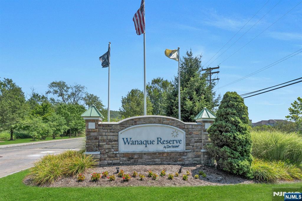 Welcome to your dream home in Wanaque Reserve â€“ premier 55+ corner unit! Discover this immaculate Colfax model corner condo in the highly sought-after Wanaque Reserve, a premier 55+ adult community. This light-filled home offers 2 spacious bedrooms, including a serene primary suite with a walk-in closet and a luxurious en-suite bath featuring a double-sink vanity and a large walk-in shower. The inviting kitchen is a chefâ€™s delight, showcasing granite countertops, cherry cabinetry, and newer stainless-steel appliances & water heater & water cop. A conveniently located laundry room includes newer washer, dryer, and utility sink. Beautiful hardwood floors flow through the formal dining room and living room, which opens to a private patio with serene, wooded viewsâ€”perfect for enjoying morning coffee in total privacy. A versatile den/library offers extra space for work or relaxation, unit comes with parking space #6. Wanaque Reserve residents enjoy access to a state-of-the-art clubhouse, packed with amenities designed to enrich your lifestyle, from fitness facilities to social activities. Tastefully decorated and meticulously maintained, this move-in-ready home is sure to impressâ€”schedule your showing today!