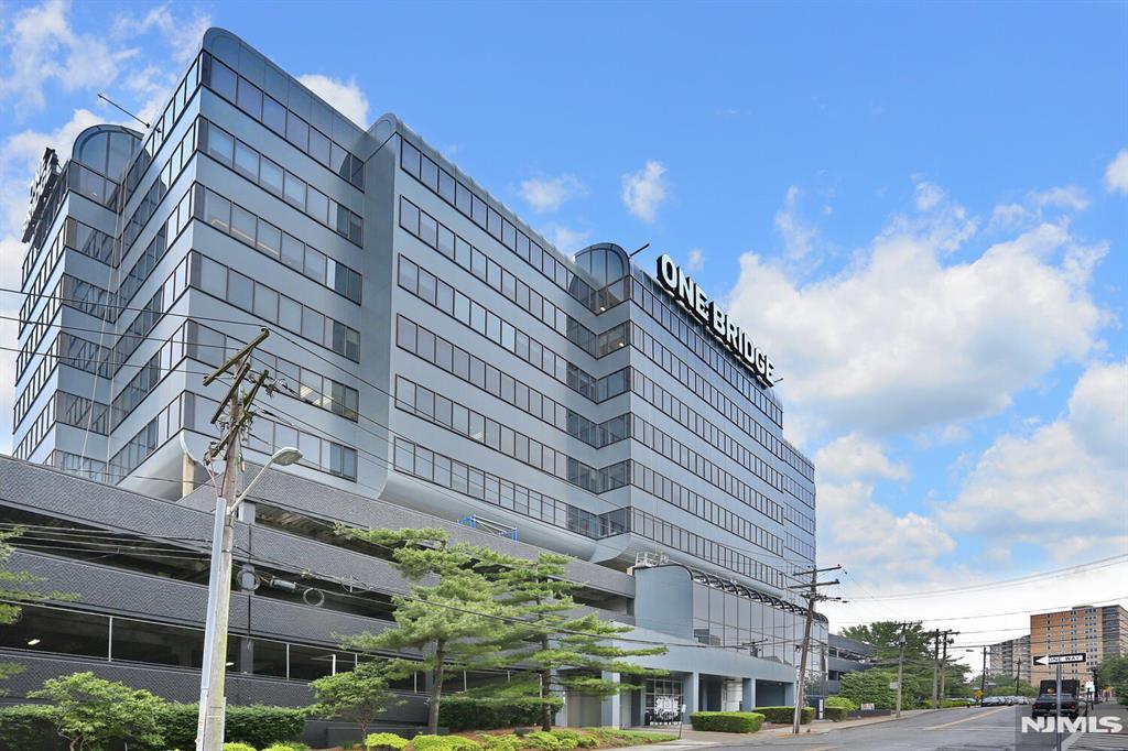 One Bridge Plaza in Fort Lee, conveniently located next to the George Washington Bridge, is an ideal office space for anyone. This fully finished office spans approximately 5,000 square feet and boasts stunning views of the bridge. It is ready for immediate use. The office features a luxurious entrance foyer and a conference room. Included in the space are a private office, a common desk, a computer, and all necessary office equipment. Additionally, tenants have access to a shared cafeteria, and utilities such as heat, electricity, and internet are all included in the rent. The One Bridge building underwent renovations in 2022, including updates to the exterior, hallways, tenant bathrooms, and lounge. The rent also covers on-site property management and 24-hour security. There is ample parking available with 78 surface parking spaces and 475 covered parking spaces.