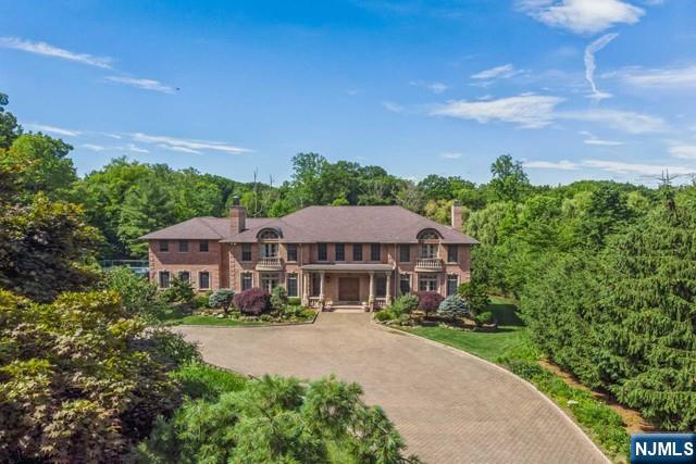 MAJESTICALLY SET ON 2 MANICURED ACRES, THIS BRICK COLONIAL MANOR IS THE EPITOME OF STATELY STYLE & ELEGANCE. CLASSIC & TIMELESS ARCHITECTURE DEFINE THIS HOME BUILT IN 2007 WITH EXTRAORDINARY ATTENTION TO DETAIL AND QUALITY. THE GRACIOUS 2 STORY FOYER WITH A BRIDAL STAIRCASE SETS THE TONEFOR THE MAIN LEVEL WITH 10' CEILINGS AND DETAILED MOLDINGS. THIS HOME SHOWCASES APPROXIMATELY 11,000 SQUARE FEET OF LUXURIOUS LIVING SPACE. THE MAIN LEVEL OFFERS A 2 STORY GREAT ROOM W/FPL, DINING ROOM W/FPL,FORMAL LIVING ROOM, LIBRARY/FPL/FULL BATH, CLIVE CHRISTAIN KITCHEN W/HIGH-END APPLIANCES, BREAKFAST AREA EXITS TO STONE PATIO, POWDER ROOM & MUD ROOM. THE SECOND LEVEL IS COMPLETE WITH 2 PRIMARY SUITES PLUS 3 ENSUITE BEDROOMS.THE LOWER LEVEL OFFERS A REC. ROOM,THEATER,GYM, BEDROOM/BATH, WINE CELLAR & INDOOR POOL W/SAUNA & WALLS OF GLASS OPENING TO THE PATIO WITH HOT TUB. ALL AMENITIES INCLUDING A SPORTS COURT & OUTDOOR KITCHEN. ENJOY ALPINE'S LOW TAXES & AWARD WINNING SCHOOLS JUST 7 MILES TO NYC.