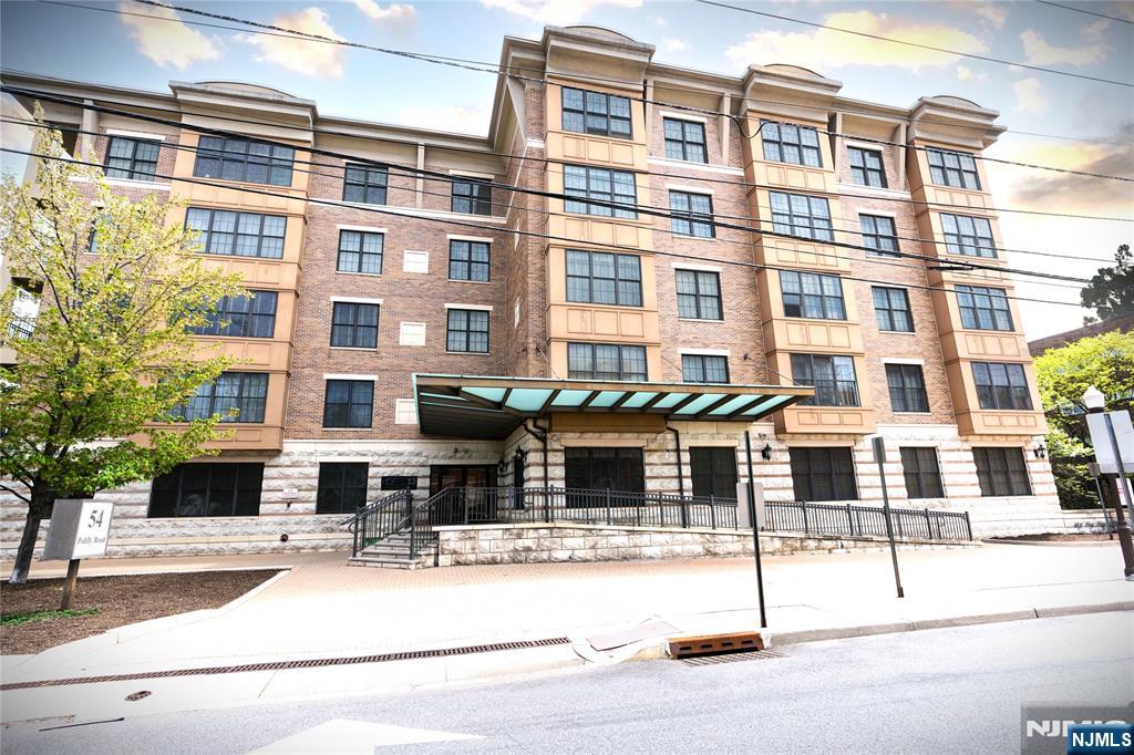 Very Large and Spacious Corner Apartment with 1500sf is Perfect for Your New Home! Open-Concept Living with Hardwood Flooring Throughout, Central Air, Full Size Washer/Dryer, Recessed Lighting, Crown Molding and more. Large Island with Granite Counter has seating for four. Large Pella Windows allow tons of Natural Light in! French Doors open to some outdoor space on your Private Balcony. Primary Suite with spacious Walk-in Closet! Two Parking Spaces included. Newer Gym on first floor. Conveniently located across from NYC Bus Stop and one block from Essex St. Train Station. Walking distance to Hackensack Meridian Health and Bergen County Courthouse. Pet friendly building! Investors welcome, can immediately rent out.