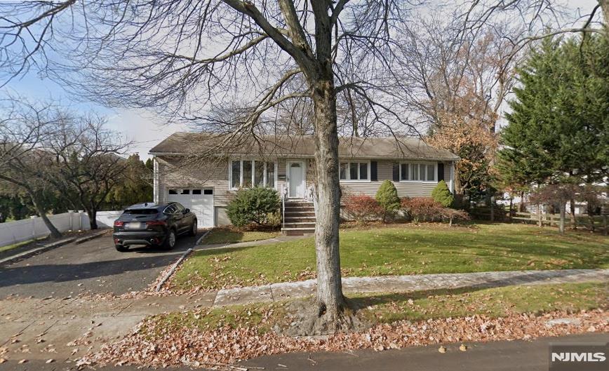 This fully renovated corner-lot ranch house features a new roof, modern exterior with neutral paint, white trim, and large windows. Inside, the open-concept layout includes hardwood floors, recessed lighting, and abundant natural light. The kitchen is equipped with custom cabinetry, stainless steel appliances, and quartz countertops. The home offers 3 bedrooms, 2 full bathrooms, and a half bathroom, all updated with sleek, modern finishes. This property offers an attached garage, a finished basement with an independent entrance perfect for a family room, home office, or gym and a back patio with spacious yard space.