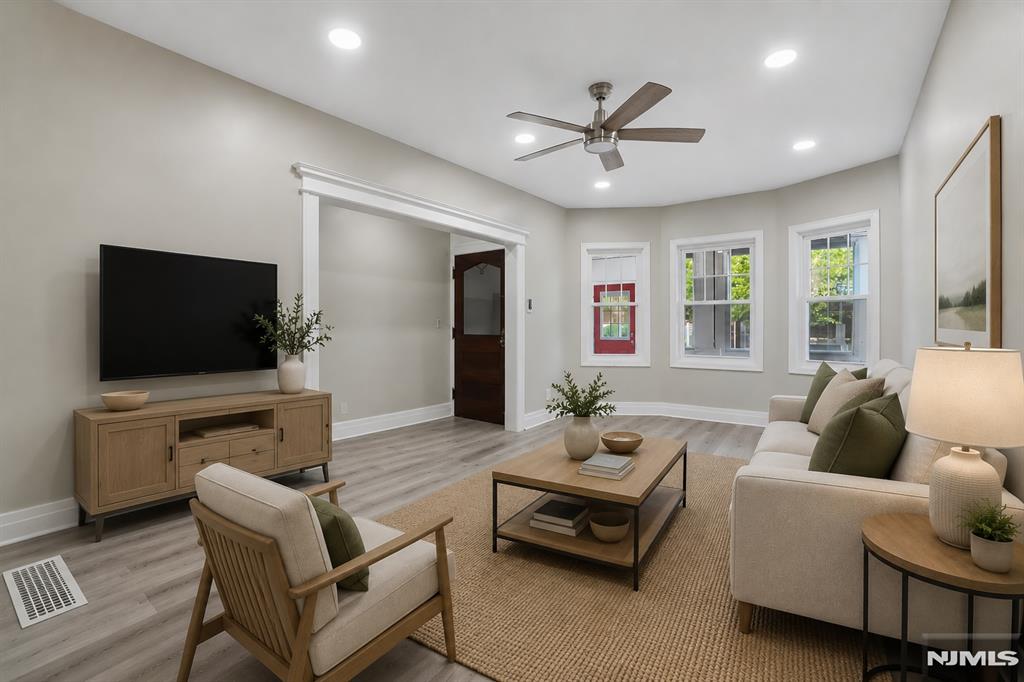 Move-in ready, single-family home centrally located in the vibrant Bergen-Lafayette section of Jersey City. This impressive 1,855-square-foot residence, built in 1900, offers timeless architecture with newly renovated updates throughout. The home features 5 bedrooms and 2.5 bathrooms, freshly painted walls, new flooring, all new windows, and renovated bathrooms. The fully renovated kitchen features updated cabinets, countertops, a kitchen island, and new Stainless appliances. The primary bedroom offers a partial view of NYC. Additional improvements include a new dryer and a new water heater for added efficiency and comfort. A full, partially finished basement provides extra living space, storage, or recreation potential. Exterior features include a convenient carport for off-street parking. Ideally located near local parks, the light rail, public transportation, shopping, and restaurants, this home offers easy access to NYC. Do not miss this property!