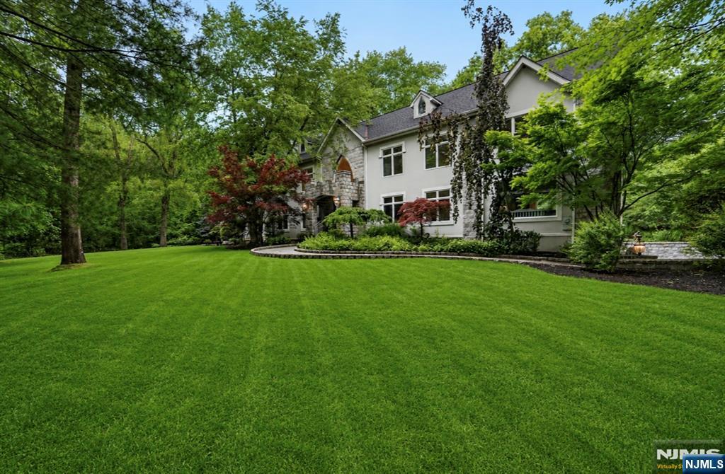 This exceptional castle-like 7-bedroom, 5.5-bath estate blends timeless architecture with modern luxury. The exquisite Ulrich kitchen features an oversized island, premium finishes, and a charming breakfast area nestled within a turret. Entertain in the banquet-sized formal dining room, dramatic two-story living room with fireplace and spectacular picture windows, and the expansive family room with custom built-ins, gas fireplace, and spiral staircase. The main level also offers a private office, bedroom with full bath, laundry room, and custom oak wet bar. Three staircases lead to the second floor, where the luxurious primary suite features a private balcony set within one of the homeâ€™s signature turrets. Four additional spacious bedrooms and three full baths complete the upper level. The finished lower level is ideal for entertaining or multi-generational living, featuring a private in-law suite with its own kitchen, bedroom, full bath, and living room. Additional highlights include a gym, wine cellar, tasting room, newer Ulrich full bath, and oversized mud room. Car enthusiasts will love the oversized 5-car garage, consisting of two tandem bays plus an additional bay, offering abundant room for vehicles, storage, and hobbies. A newer heating system (2021) adds efficiency and comfort. Set in prestigious Saddle River, this remarkable estate offers the elegance of a European-inspired manor, exceptional privacy, top-rated schools, and convenient access to New York City.
