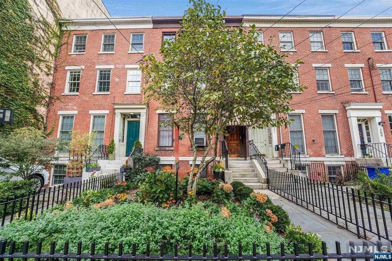 Nestled on a historic row in the highly sought-after neighborhood of Paulus Hook, this Victorian house welcomes you with a beautifully landscaped front garden and a warm brick facade. Built in the mid-1800s, this home has classic charm and timeless appeal. The existing original detail of crown moldings, ceiling medallion, and mantle help you to glean the craftsmanship of a bygone era while making yourself comfortable in the present. Facing east, natural light fills the spacious rooms. Four floors of living space allow for all of your needs- from bedrooms to storage, to entertaining or private time. A large fully landscaped backyard with a patio and shed creates a coveted urban retreat. This home is a rare find with its historic charm, development potential, and unbeatable location. Residents will enjoy all the perks of downtown Jersey City living with proximity to shops, restaurants, parks, easy access to public transportation including the PATH train and ferry.