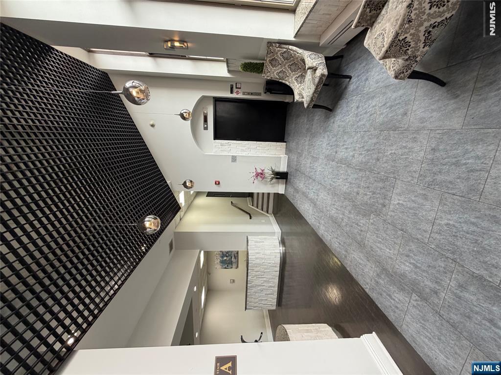 Modern condo featuring a sleek, updated kitchen with newer appliances, a spacious bedroom with a large closet, and a beautifully bathroom. The unit offers high ceilings that create an open, airy feel, along with central A/C for year-round comfort. Laundry is conveniently located in the building. Ideally situated close to major highways and easy access to trains to NYC perfect for commuters. low taxes for 2026 Estimated around $3554 & HOA just $230 a month including the water. PRICE TO SELL