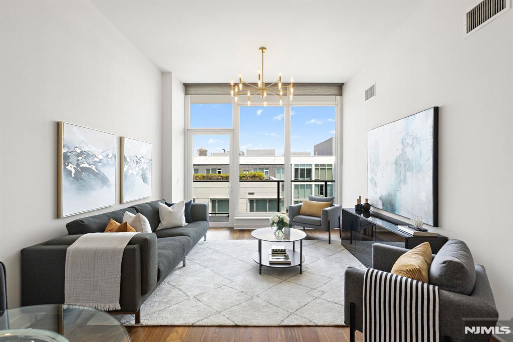 (Contact NELSON CHEN at 2 0 1 - 8 8 6 - 8 0 0 0) - PENTHOUSE 702 at THE AVENUE COLLECTION Building 1200 - This is the one you've been waiting for! An ideal split-bedroom floorplan on the top floor with 1279-SF and a 27-foot glass walled terrace boasting beautiful views of Manhattan and the Hudson River. Incredible ceilings almost 11-feet tall and walls of floor-to-ceiling windows grace this home with amazing light and enhance the feeling of space. Distinct upgrades include newly refinished wood floors, custom LED light fixtures and blackout window blinds. Monogram appliances, fixtures by Kohler, and layers of lighting grace the kitchen and baths. A deeded parking space completes this rare offering in Port Imperial's finest building just 2 blocks from the ferry terminal. Come experience the boutique lifestyle of the Avenue Collection that includes 24-hour concierge service, health club, movie theatre, kid's playroom, penthouse level Skyline Lounge and the ultimate 3rd level resort style pool deck. Welcome Home - (Presented by THE CHEN AGENCY, 2 0 1 - 3 4 6 - 8 8 8 8, N e l s o n @ C h e n A g e n c y . c o m)