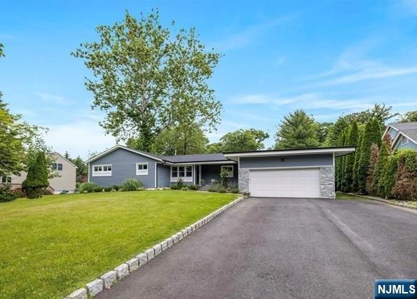 Beautifully renovated expanded ranch located in the highly desirable Park Ridge neighborhood. Renovated in 2020, this home features a modern gourmet kitchen with quartz countertops, custom cabinetry, stainless steel appliances, and a wine bar. The spacious family room offers abundant natural light and sliding glass doors leading to the backyard deck. The home includes generously sized bedrooms with ample closet space, including a primary suite with a walk-in closet and private full bath. Enjoy a large backyard ideal for outdoor entertaining and everyday enjoyment. Conveniently located near shopping, restaurants, parks, schools, and transportation.