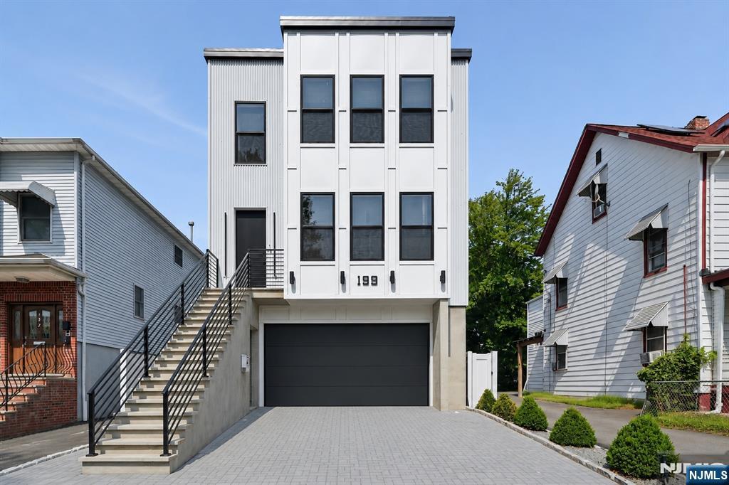 This is arguably one of the most unique new construction homes you will ever see. A modern loft style two family home where each apartment is designed as its own three level residence, creating the feel and privacy of a luxury single family townhouse. Welcome to 199 N Park Street, ideally located on the border of Glen Ridge. This one of a kind design offers features rarely found in today's market and truly needs to be seen in person to be fully appreciated. Unit 1 occupies the entire front of the home across three levels, while Unit 2 occupies the entire rear across three levels, giving each residence exceptional privacy and independence. Each unit features 3 spacious bedrooms, each with its own en suite bathroom, plus an additional half bathroom for a total of 3 full bathrooms and 1 half bathroom. The open concept living area is highlighted by dramatic double height ceilings, a modern white kitchen with granite countertops, and abundant natural light. The top level offers a private family room overlooking the main living area while providing access to the roof. Complete with large living spaces, a generous backyard, and an architectural design unlike anything else around, this is a truly exceptional opportunity you do not want to miss.