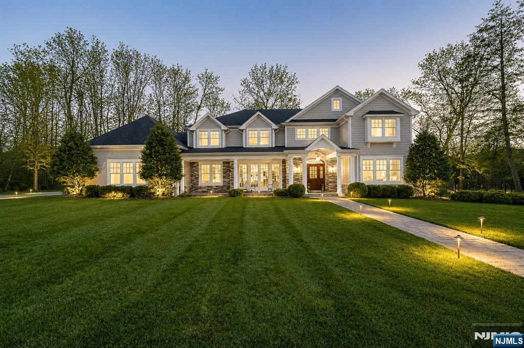 Situated on a quiet cul-de-sac in Old Tappan, this exceptional custom-built home offers approximately 5,914 square feet of thoughtfully designed living space on a beautifully landscaped 0.87-acre property within the town's highly regarded Blue Ribbon school district. A grand two-story foyer welcomes you into an expansive floor plan featuring a first-floor bedroom, private office, formal living room, and a spacious family room centered around a gas fireplace. The eat-in kitchen is appointed with a large center island and sliding glass doors that open to the patio, creating an effortless transition to the outdoor living space. A custom wet bar with sink adjoins the formal dining room, making entertaining easy. The second level features four generously sized bedrooms, a second-floor laundry room, and an oversized bonus room ideal for a recreation room, home gym, media room, or office. The primary suite includes dual walk-in closets and a spacious bath with double vanity, soaking tub, and separate shower. Combining quality craftsmanship, functional design, and an exceptional location, this home offers a rare opportunity in one of Bergen County's most desirable communities.