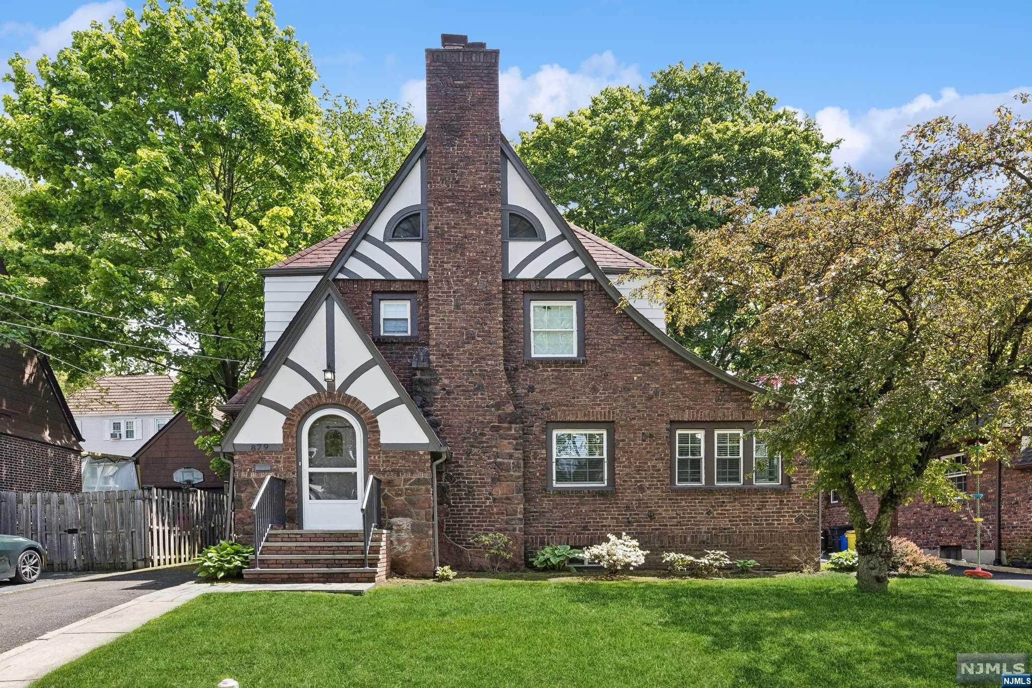 Charming Tudor Colonial in quiet area of Teaneck. Living room, family room, dining room with french doors to 3 season porch. Expanded eat-in kitchen with double sinks, double ovens & 2 dishwashers. Second floor, primary bedroom with wall of closets, 2 additional bedrooms, full bathroom. Walk up finised attic is perfect for an office or guest space and has plenty of storage space. Finished basement, rec room, full bathroom, laundry room and lots of storage. Backyard is great for playing or entertaining. Detached oversized garage. Close to houses of worship, shopping and transportation.