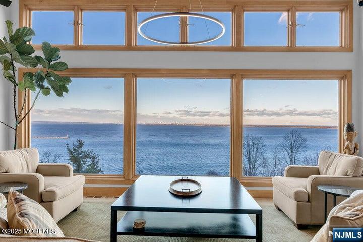 Tower House is a one-of-a-kind bluff-top residence defined by its iconic 35-foot architectural tower and commanding views above the New York Harbor. Inspired by timeless English architecture, the home features handcrafted brickwork, salvaged gothic doors, soaring ceilings, custom millwork, and beautifully updated finishes. Offering approximately 3,700 sq ft, nearly every room captures sweeping harbor, skyline, and ocean views. Multiple Ipe decks and terraced stone gardens create exceptional outdoor living. The 1,300 sq ft primary suite occupies the upper tower, offering unmatched privacy, breathtaking sunrises, and a private terrace. Tower House is a rare waterfront masterpiece where architectural character meets an extraordinary setting and timeless elegance.
