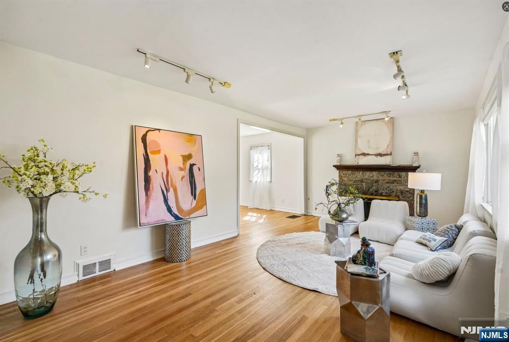 Welcome to The Johnson Avenue Gallery Home! Set on one of Teaneck's most desirable streets, this bright 3-bedroom, 1.5-bath colonial offers oversized rooms, abundant natural light & meaningful potential for future customization. Situated on a 6,250 sq ft lot, the property provides comfortable living today with room to grow (subject to approvals). The first floor features a spacious living room anchored by a wood-burning fireplace, along with freshly painted living & dining rooms that enhance the home's light-filled atmosphere. Sliding doors off the dining room open to a large deck overlooking a deep backyard ideal for entertaining, gardening or play. A paver driveway & walkway add a polished exterior approach. The kitchen features a layout that supports everyday living while offering opportunities for future personalization. Upstairs are three oversized bedrooms, including a primary with three closets, & an extra-large bathroom with a jacuzzi tub, stand-up shower, large windows & a skylight. One bedroom has been freshly painted for added move-in appeal. The unfinished basement offers excellent storage & a bonus-room area w/ flexible potential. Outdoor amenities include a large deck, one-car garage & backyard shed, with ample space for a hammock, playset or yard-friendly activities. Location highlights: Proximity to houses of worship, Parks, Community amenities, Steps to Express Bus to Port Authority (approx. 25-minute commute) & Quick Access to I-95 & Route 4.