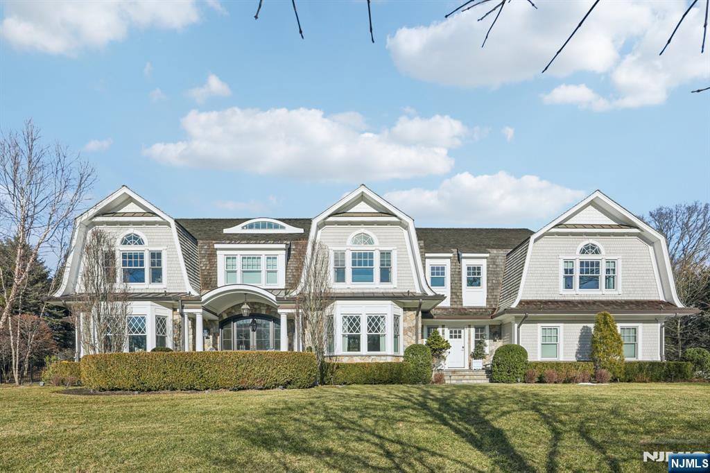 Experience the epitome of opulence and sophistication in this one-of-a kind residence. Set in a prime Franklin Lakes neighborhood. A show-stopping Hampton style cedar and stone estate offering over 9,000 sq ft of magazine-worthy living with a chic and contemporary edge. Thoughtfully designed to accommodate daily life and special occasions. Enter the sun drenched foyer, to open living spaces with clean lines and modern esthetics. The main level features generous open living spaces that connect to beautifully landscaped grounds with stunning heated pool house featuring a full bath, wall of glass, a spacious living room with fireplace. The outdoors also offers a saltwater oversized beach entry pool with spa. Beautifully designed great room with built-ins, a fireplace and French doors flows seamlessly to expansive bluestone covered patio. First floor includes a beautiful dining room with butler's pantry, a stunning chef's kitchen with oversized island, leathered granite, reclaimed wood accents. Gorgeous library. Upstairs the primary suite offers a private retreat complete with sitting area by the fireplace, spa-like bath and double closets. The second floor also includes 4 additional e-suite bedrooms. A fully finished lower level features a rec/media room with custom built wet bar, gym studio and guest quarter. Lush landscaping, dramatic lighting, whole house generator and Sonos complete this extraordinary offering. Luxury living at it's finest.