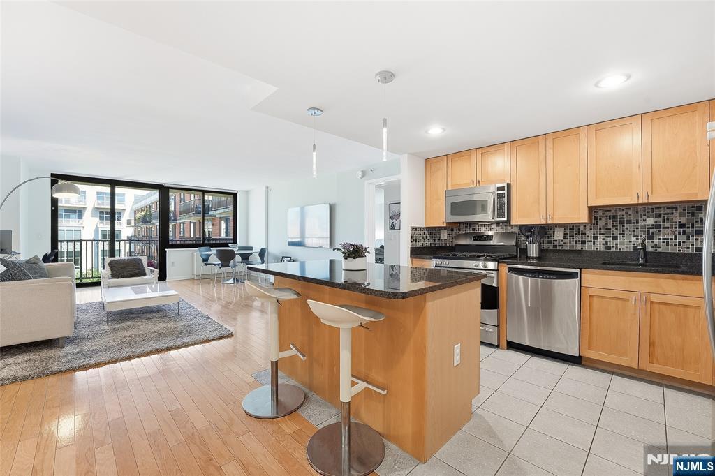 Welcome to Residence 11A at 700 Grove Street, a spacious high floor 2 bedroom, 2 bath condominium in Downtown Jersey City, just one block from Hoboken. Spanning approximately 1,373 sq.ft., this east facing home offers stunning New York City skyline views, abundant natural light, and a large private terrace. The thoughtfully designed layout features expansive living and dining areas, large windows, and an open concept kitchen with generous cabinetry & counter space. The oversized primary suite includes a walk-in closet with custom built-ins, and en-suite bath with upgraded double sink vanity. The spacious second bedroom features a large closet with custom Elfa shelving & additional built in cabinetry and storage. Additional highlights include hardwood flooring, central air conditioning, an in-unit Bosch washer & dryer, and garage parking for one car. 700 Grove Street is a highly sought after full service building offering a 24 hour concierge, fitness center, landscaped courtyard, resident lounge, childrenâ€™s play area, shuttle service to the Hoboken PATH, & on-site management. Conveniently located near the Hoboken & Newport PATH stations, Light Rail, ferry service, major highways, shopping, dining, parks, Whole Foods, Acme Supermarket & Target.
