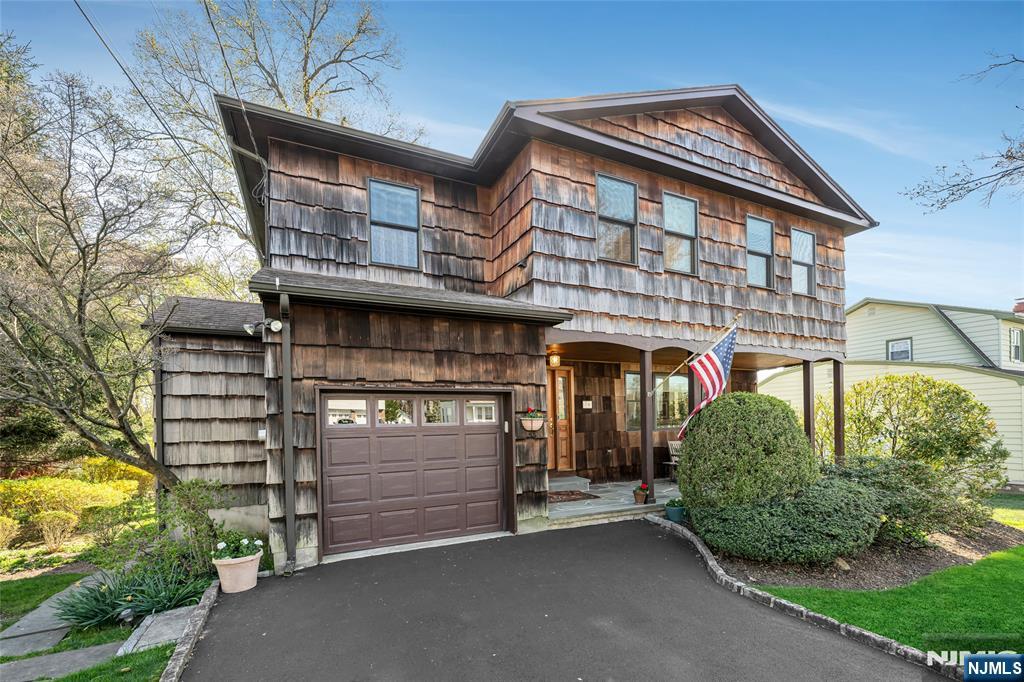 Set on a generous half-acre in a quiet West Caldwell neighborhood, this spacious home at 10 Woodmere Rd. offers a comfortable blend of space, functionality, and standout design features. A welcoming front patio creates an inviting first impression, perfect for morning coffee or relaxed outdoor seating.Inside, the home opens to a thoughtfully designed layout filled with natural light. The expansive kitchen serves as a true centerpiece, featuring abundant cabinetry, extensive counter space, and a large center island ideal for meal prep, casual dining, or gathering. It flows seamlessly into the show-stopping great room, highlighted by soaring cathedral ceilings, exposed wood beams, a fireplace, and direct access to the deck. Creating a warm, open space well-suited for everyday living and entertaining.The home includes 4 generous bedrooms & 3 full bathrooms, including a spacious primary suite with a private en-suite bath. A second-floor laundry area adds everyday convenience, while the additional bedrooms offer flexibility for guests, work-from-home needs, or hobbies.Outside, the large, flat backyard provides ample space for recreation, gardening, or outdoor enjoyment. With its convenient location near local amenities, easy NYC transportation, this home brings together space, function, and a welcoming atmosphere in one place.