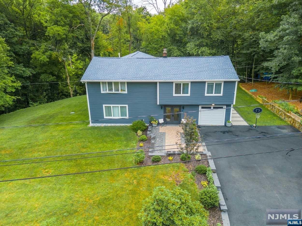 Welcome to this modern style and completely renovated home in Kinnelon's Lake Reality Community. This elegantly reimagined home is not to be missed! An open floor plan and consistent high-end finishes integrate the gourmet kitchen and breakfast area, while sleek lines seamlessly blend the living and dining rooms. Easy egress to the back patio and backyard makes for convenient day-to-day living and entertaining. The second floor features a sweeping primary bedroom with en suite bath and walk-in closets, Three more bedrooms, & bonus multi-purpose space, and second living room. Optional granted membership for private Lake Reality with $640 annual membership fee. New roof with thirty-year transferable warranty, new siding with UV protection, refinished floors on 2nd floor, new laminate floors with heating on the 1st floor. With Kinnelon schools, wonderful parks, trails, reservoirs, recreation programs, proximity to shopping and NYC transportation, this is the place!