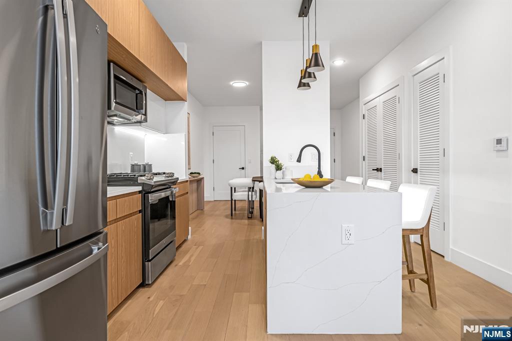 SELLER PAID CLOSING COSTS- LIMITED TIME OFFER. PENTHOUSE UNIT- Introducing Tailor House Union City, Hudson Countyâ€™s newest boutique luxury condominium. This intimate elevator building offers just 48 thoughtfully designed residences, combining privacy, sophistication, and urban convenienceâ€”all just 15 minutes from NYC by bus. Tailor House redefines modern living with oversized 1- and 2-bedroom homes featuring open-concept layouts, soaring 9â€“10 ft ceilings, and generously sized bedrooms. Sleek kitchens are outfitted with waterfall quartz countertops, European-style two-tone oak cabinetry, GE Professional Series appliances, and select units include contemporary islands. Bathrooms evoke a spa-like feel with floor-to-ceiling porcelain tile, glass-enclosed showers, and marble-topped vanities. Residents enjoy upscale amenities including a fully equipped fitness center, stylish lobby, landscaped garden terrace, and smart security with Swiftlane intercoms. Assigned parking is included, with additional spaces available for purchase, and a 5-year tax abatement adds even more value. Nestled in the heart of historic Union City, Tailor House offers a refined lifestyle where modern design meets everyday convenience.