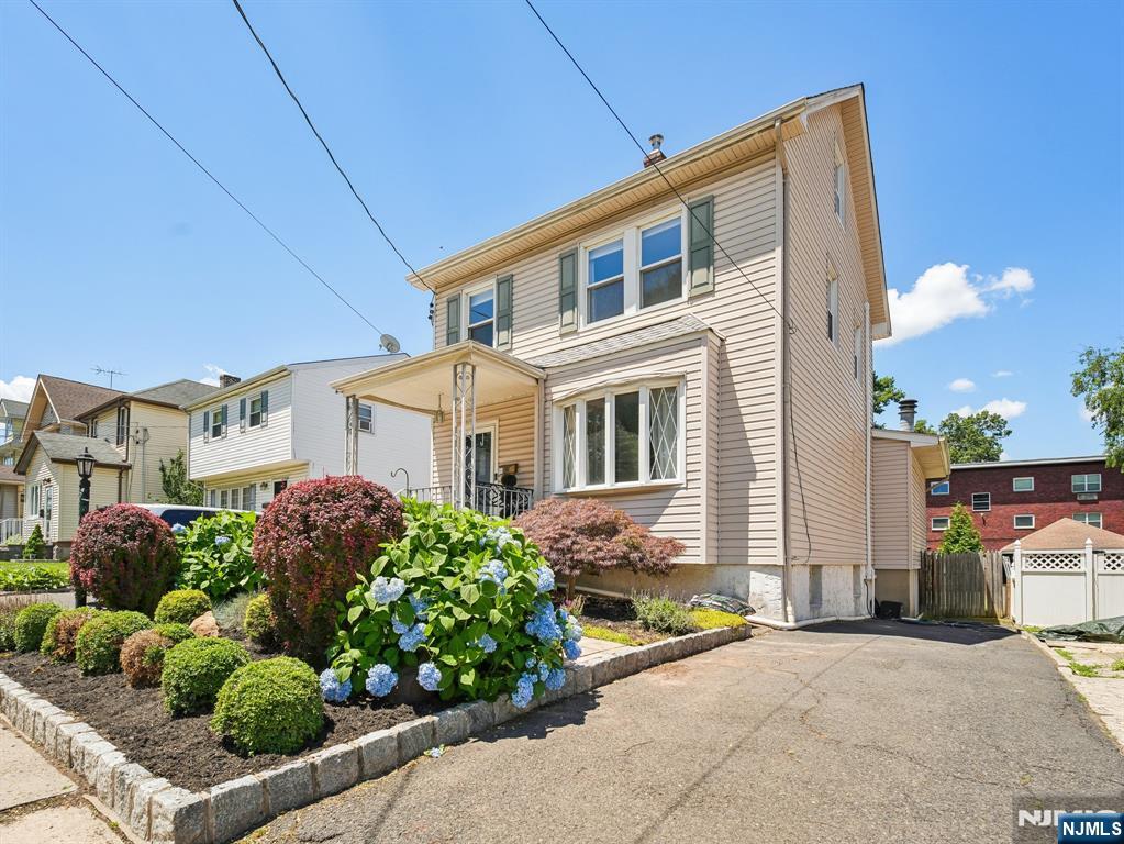Spacious living room, dining room, family room with vaulted ceiling, gas fireplace. Renovated kitchen, white wood cabinets, quartz counter tops stainless applicances. Beautiful floors on both levels. Deep fenced private back yard, deck. Full basement with laundry full bathroom. Walk to NYC bus