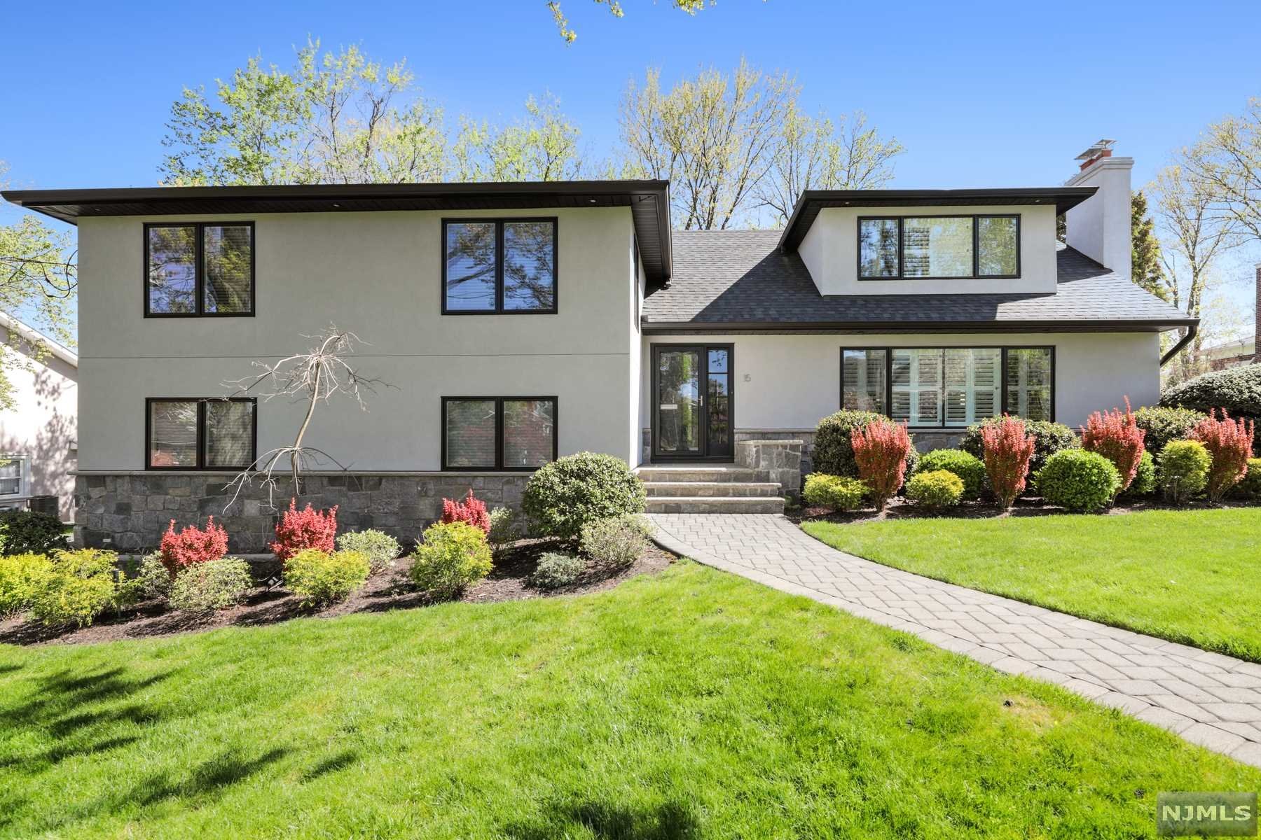 Exceptional newly renovated home located in the picturesque section East hill of Englewood Cliffs. This expanded home has extraordinary attention to detail, from the stone & stucco facade to the open concept kitchen equipped with luxurious kitchen appliances down to the beautiful hardwood used throughout the home. Plenty of natural sunlight throughout from the oversized windows dressed with high-end savannah shades for privacy. The primary living space offers a spacious living room with a stone gas fireplace, an open concept kitchen with a large kitchen island, an eat-in area, plus a sun-drenched formal dining room. This home offers two primary suites, with one being secluded on its own floor. Separate level family room with ground-level access, a newly upgraded deck, a two-car garage with epoxy flooring, a generator, a perfectly manicured lawn, and just minutes to the GWB, this home is a must-see!