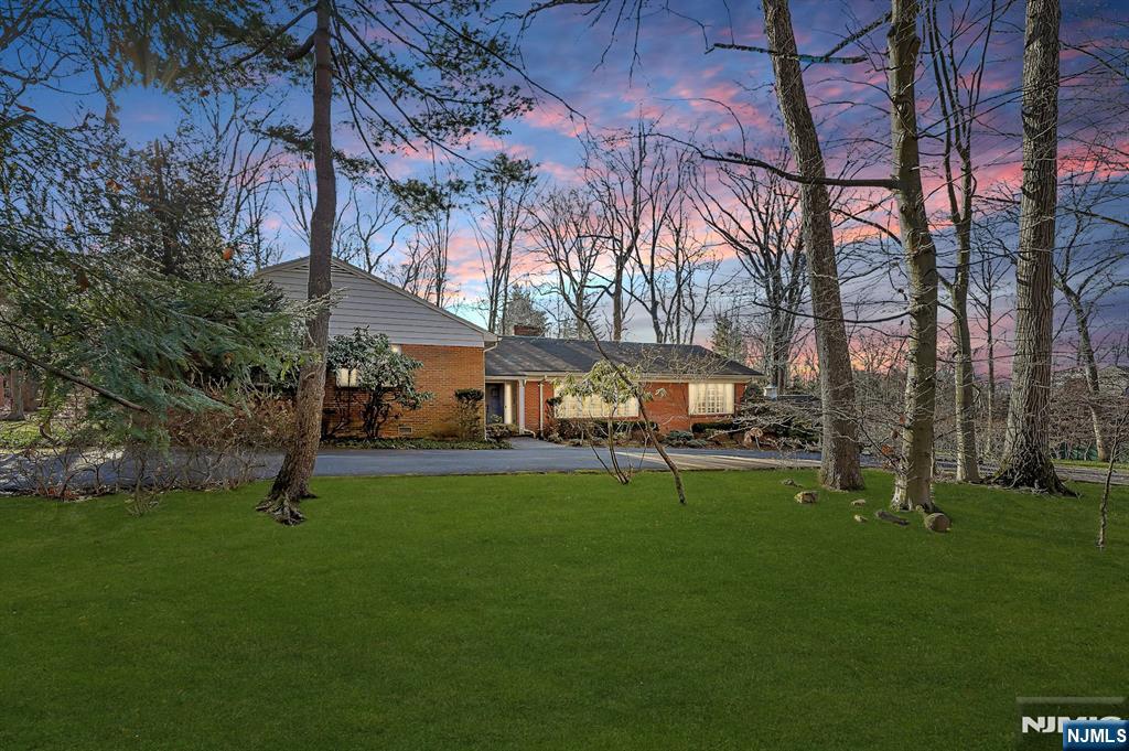 Location! Location! Location! A rare opportunity for a builder or buyer to build their own dream estate on a private, picturesque 2-acre property in the heart of beautiful Alpine! Nestled in one of the country's most prestigious zip codes located in Bergen County, with unlimited possibilities! This unique area is surrounded by magnificent multiple million-dollar estates, with total privacy and unlimited possibilities! Not only is Alpine known for having one of the lowest tax rates in Bergen County, but their school is rated #1 public elementary school in Bergen County and Tenafly HS is a National Blue Ribbon School. The entry foyer leads you to the formal living and dining rooms with a fireplace, eat-in kitchen and a family room, both walking out to the secluded backyard, powder room and laundry all on the first floor! The second floor includes 4 bedrooms, 2.5 bathrooms. The home is in good condition, making renovating an option! Minutes to the George Washington Bridge to Manhattan & the Palisades Parkway to NY State, easy access to major highways and airports. Alpine is surrounded by some of the finest golf & country clubs, private schools, restaurants and shopping in the area!! The perfect place for raising a family or entertaining with friends! Come make this property your true masterpiece blending luxury, comfort & sophistication!