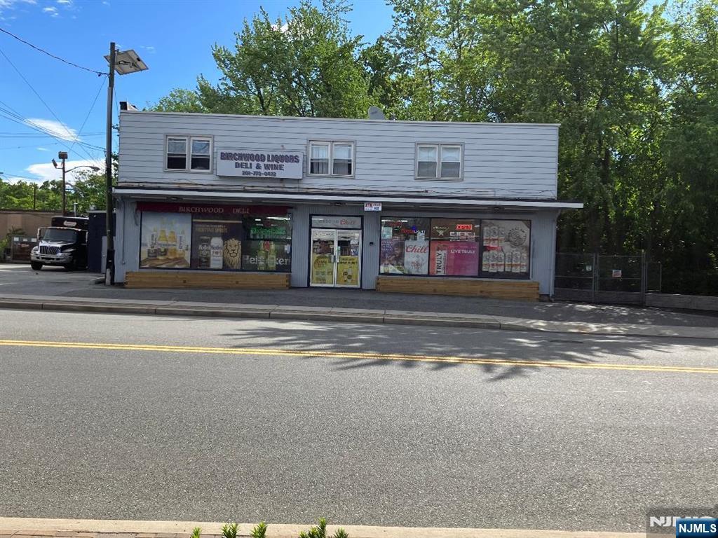 BUILDING FOR SALE. STORE & 2ND FLOOR 3 BEDROOM/2 BATH APARTMENT. SEPERATE ENTRANCE AND PARKING. USE YOUR IMAGINATION FOR USE OF THIS mixed-use property that is centrally located between several major highways, Route 80, Route 46 & Route 4 as well as the Garden State Parkway! Includes a commercial ground floor unit, currently rented since 2001 for $$6,250/m-m, as a liquor store/deli, lottery, etc. 2nd floor 3/2 apartment, could be for owner or to rent for $2800 m-m + 8 car parking for commercial unit and up to 4 car parking for rental apartment which includes 3 bedrooms, 2 baths, laundry, living room, dining room and eat in kitchen. Kitchen and baths in the apartment have been updated, new appliances. Separate utilities, 1 water bill split between 2 units. Central air in commercial unit, window units on 2nd floor. Driveway for commercial unit was re done in 2020. Rental apartment driveway and retaining wall were re done in 2024. Electrical panels were updated in 2022. Building Insurance, $6,600/yr.