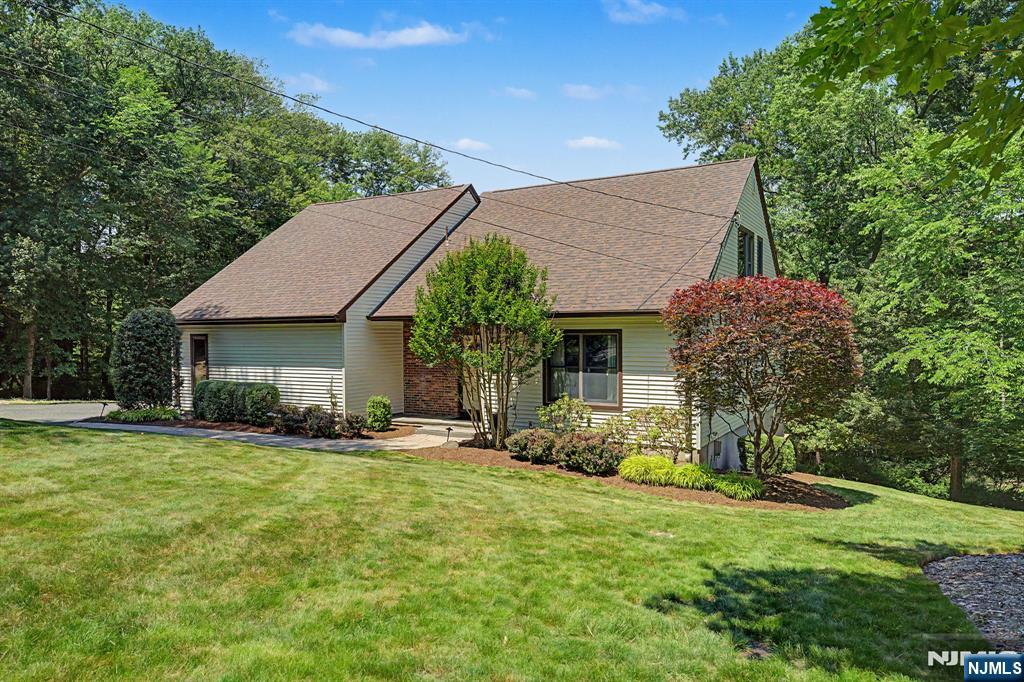 Discover this truly unique and captivating 4-bedroom, 2.5 bath home, set on a large, private lot that backs directly up to a picturesque horse farm, this home offers exceptional privacy and serene, pastoral views that are rarely found in the area. From the moment you arrive, you'll notice it's much larger than it appears. Spacious, thoughtfully designed, and brimming with character. As soon as you step into the dramatic two-story foyer, youâ€™ll be captivated by the bright, open, and airy atmosphere that flows throughout the main living spaces. The first-floor primary suite is a standout feature, offering convenient single-level living with a generous walk-in closet and private bath. Upstairs, you'll find three additional bedrooms, full bathroom plus a versatile home office/loft. The outdoor living is simply exceptional: a massive wrap-around two-tier deck provides abundant space for entertaining, dining al fresco, or simply relaxing while soaking in the peaceful surroundings. Below, a walk-out basement offers flexible potential for additional living space, recreation, or your own personal vision. Recent major upgrades include a brand-new roof, vinyl siding, new gutters, and a brand-new four-bedroom septic system. This is a rare opportunity to own a distinctive home in one of Bergen County's most desirable townsâ€”convenient to top-rated schools, parks, shopping, and major highways, yet tucked away in a tranquil, private setting. Homes like this do not come along often!