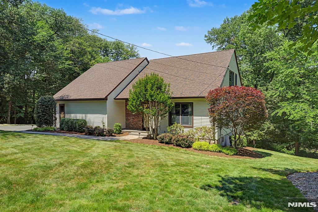 Discover this truly unique and captivating 4-bedroom, 2.5 bath home, set on a large, private lot that backs directly up to a picturesque horse farm, this home offers exceptional privacy and serene, pastoral views that are rarely found in the area. From the moment you arrive, you'll notice it's much larger than it appears. Spacious, thoughtfully designed, and brimming with character. As soon as you step into the dramatic two-story foyer, youâ€™ll be captivated by the bright, open, and airy atmosphere that flows throughout the main living spaces. The first-floor primary suite is a standout feature, offering convenient single-level living with a generous walk-in closet and private bath. Upstairs, you'll find three additional bedrooms, full bathroom plus a versatile home office/loft. The outdoor living is simply exceptional: a massive wrap-around two-tier deck provides abundant space for entertaining, dining al fresco, or simply relaxing while soaking in the peaceful surroundings. Below, a walk-out basement offers flexible potential for additional living space, recreation, or your own personal vision. Recent major upgrades include a brand-new roof, vinyl siding, new gutters, and a brand-new four-bedroom septic system. This is a rare opportunity to own a distinctive home in one of Bergen County's most desirable townsâ€”convenient to top-rated schools, parks, shopping, and major highways, yet tucked away in a tranquil, private setting. Homes like this do not come along often!