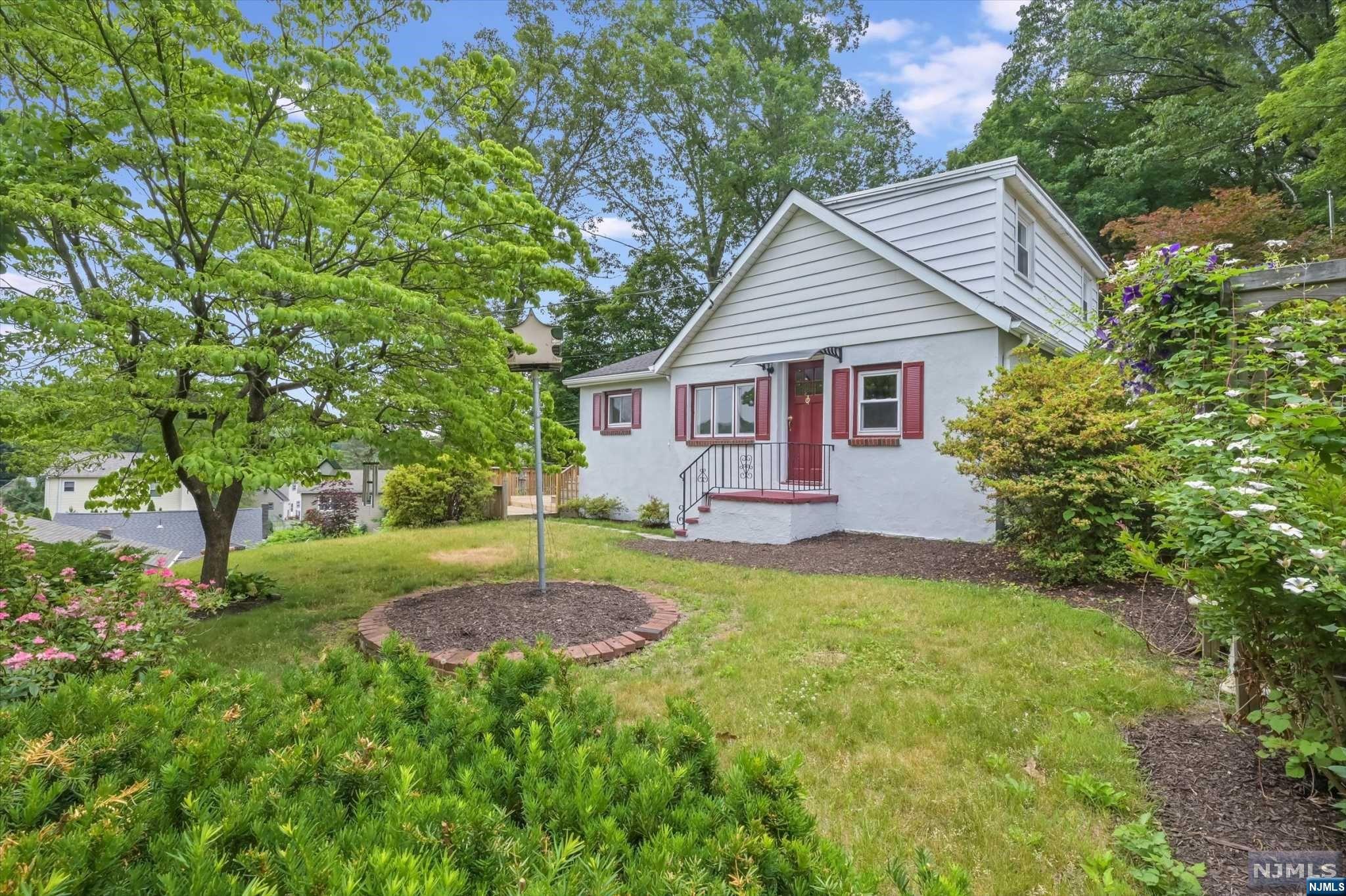 Updated Cape Cod set back off the road allowing for plenty of privacy! Enter into the living room, which leads to 2 bedrooms with ample closet space. Archway leads into the kitchen offering refinished cabinets, new wall oven, new stove and separate dining area. There is plenty of cabinetry storage for all of your kitchen needs. Kitchen door leads out to the deck. Full bathroom features a storage vanity, tub shower and sliding glass enclosure. The laundry room with new washer & dryer and slop sink is located in the bathroom. Second floor offers 1 bedroom and unfinished attic space. Bilco style doors outside lead to the unfinished basement offering utilities and plenty of storage space. There is an above ground oil tank in the basement. The deck is quite spacious offering plenty of space for outdoor dining & lounging during the warm summer months! Stairs lead down to the backyard. Lawn is well-manicured. This home is conveniently located near NYC transportation, schools & shopping!